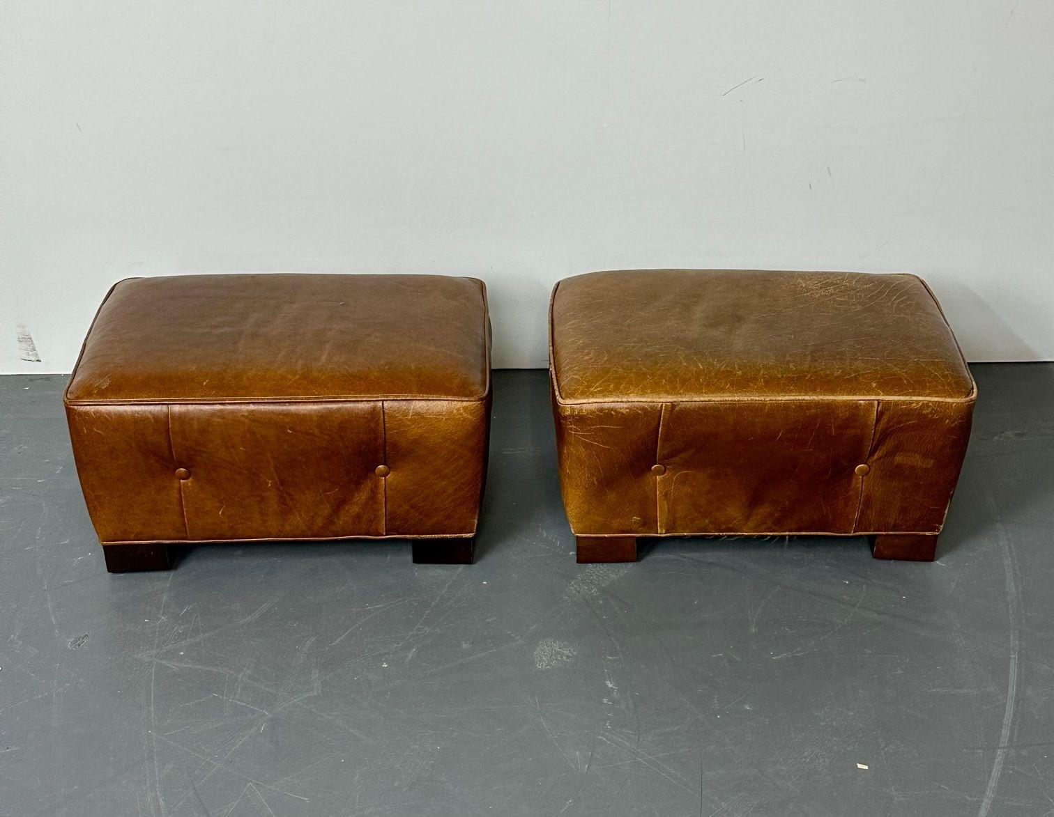 Pair of French Art Deco Style Distressed Leather Rectangular Ottomans, Low Stool
 
A rare and hard to find pair of Art Deco French ottomans or footstools with button pleated sides and mahogany feet. This fine pair will not be seen elsewhere; a