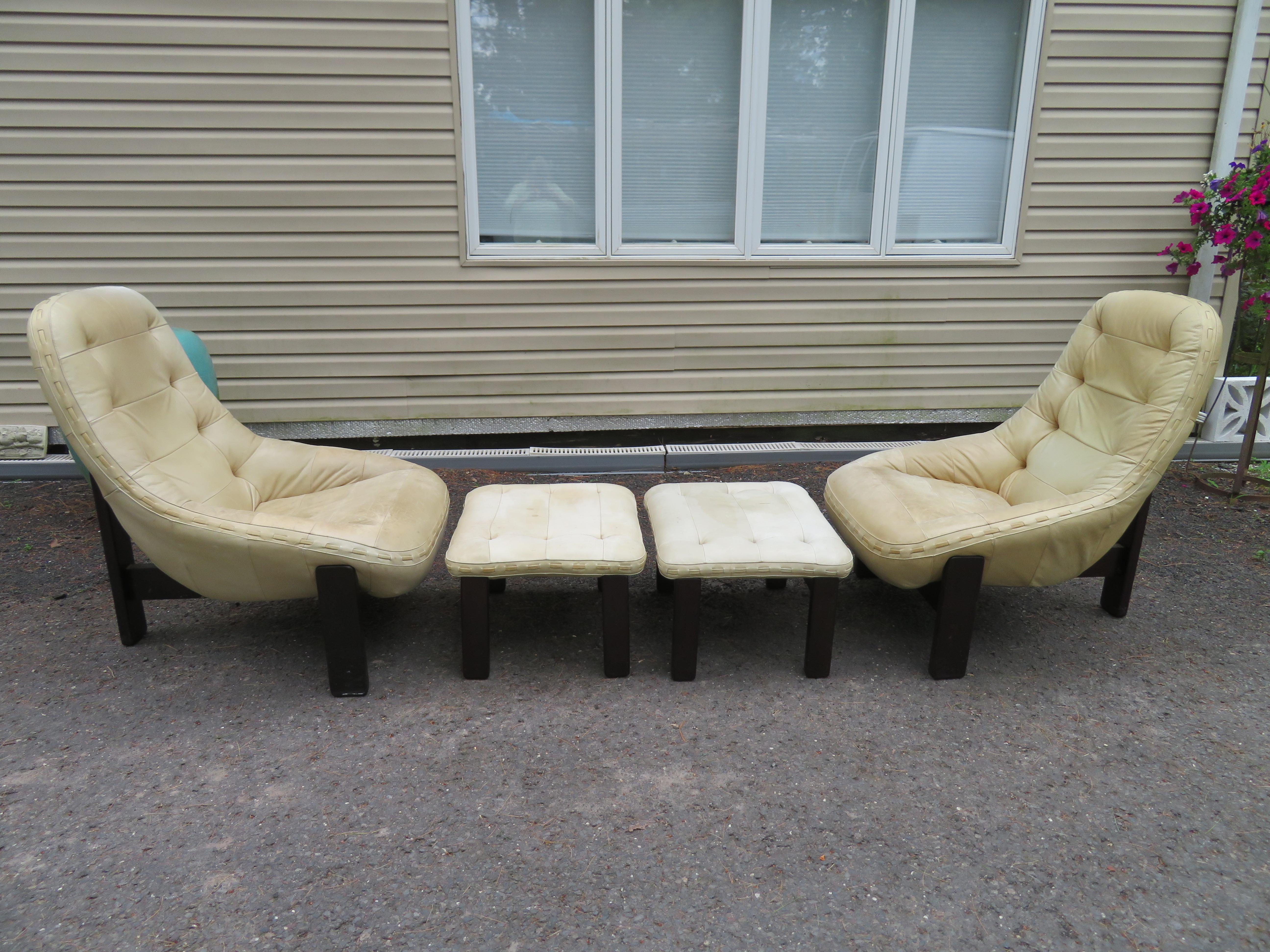 Rare pair Jean Gillon for Probel rosewood and leather lounge chairs and ottomans. The rosewood frames are in great condition with minor wear. The original beige leather is in good condition with some light wear to the seats-see photos. Both chairs