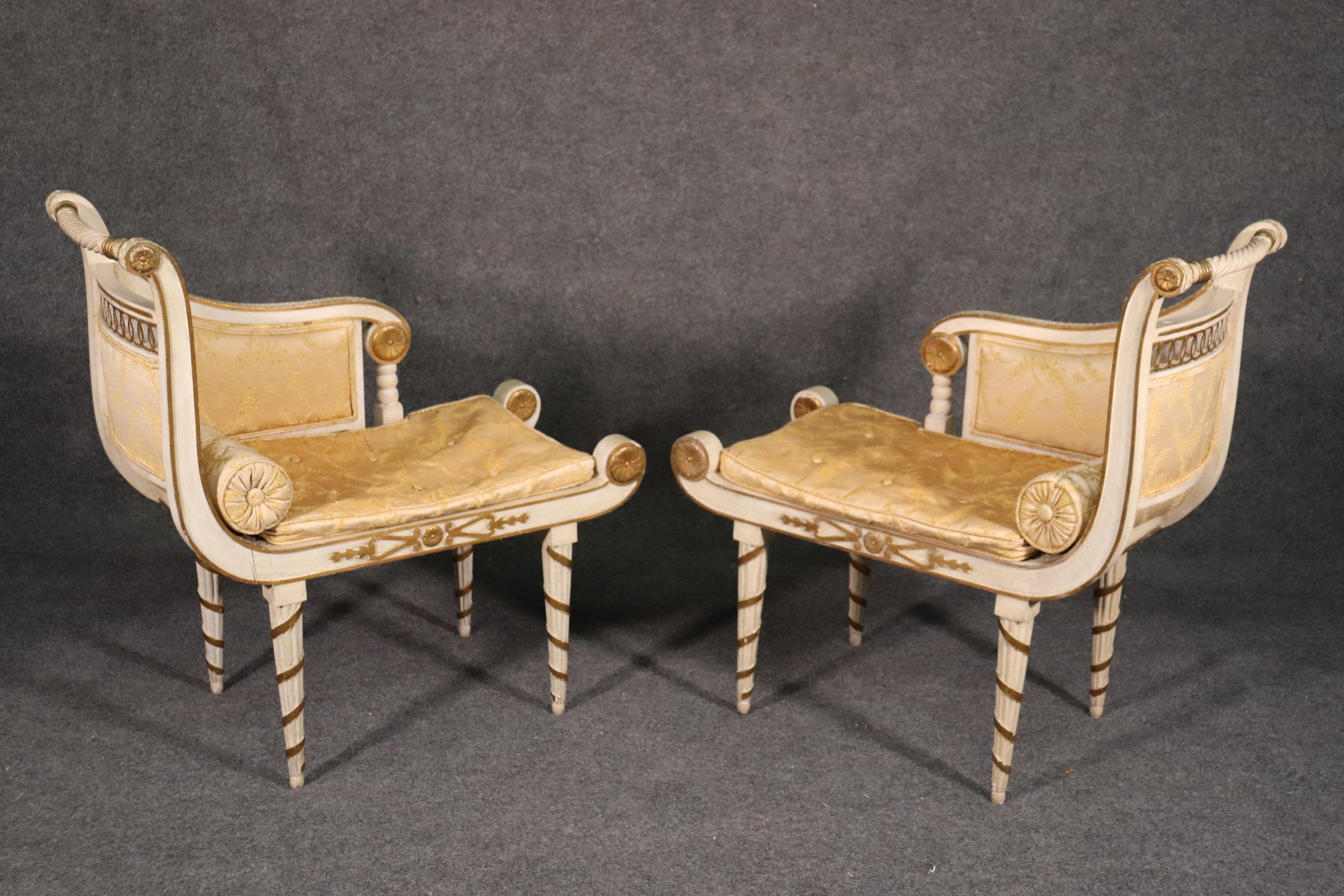 This is a very unique and beautiful pair of stools or benches shaped like mini chaises or recamiers. The chaises are in original condition and will shwo some wear and tear of the finish and the fabric but are essentially good for their 80 years of