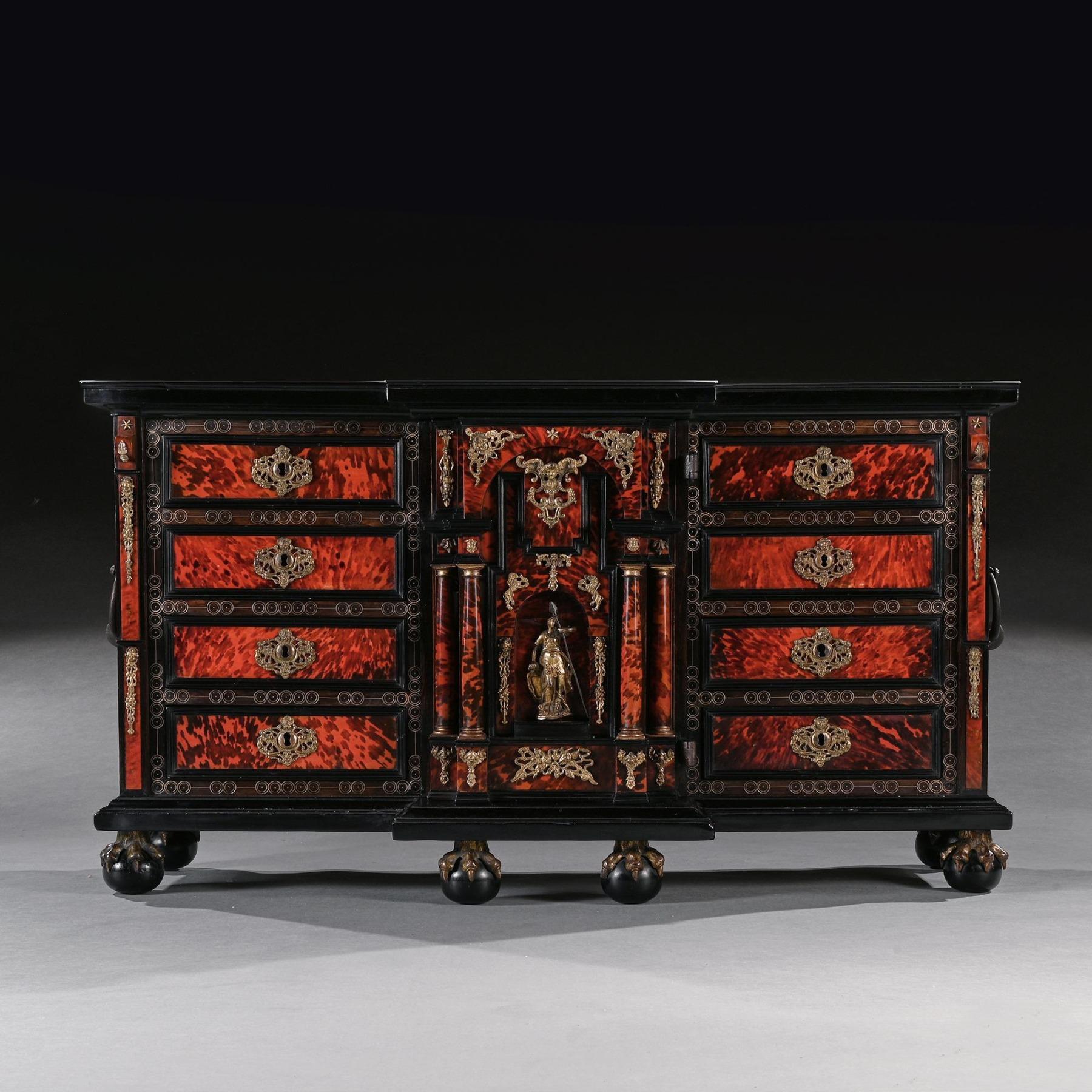 An Exceptional and rare pair of 17th Century Spanish Baroque gilt bronze and metal mounted ebonised and tortoiseshell cabinets of grand scale with Provenance.



Spain circa 1680.



The moulded top above a central door of architectural form