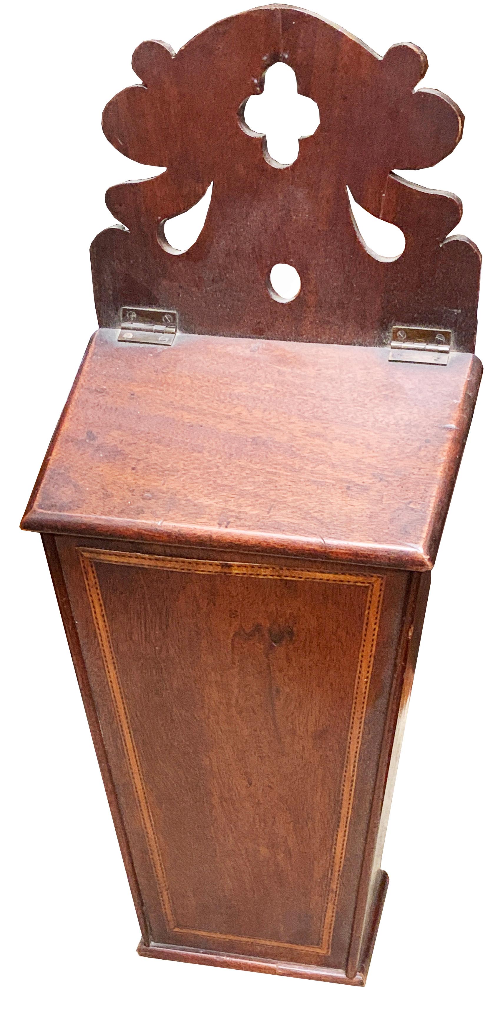 An extremely rare and delightful pair of late 18th century mahogany wall
Hanging boxes, the larger for storage of candles and the smaller for salt,
Having elegant one piece pierced fretwork backs

(These charming and practical boxes are in good