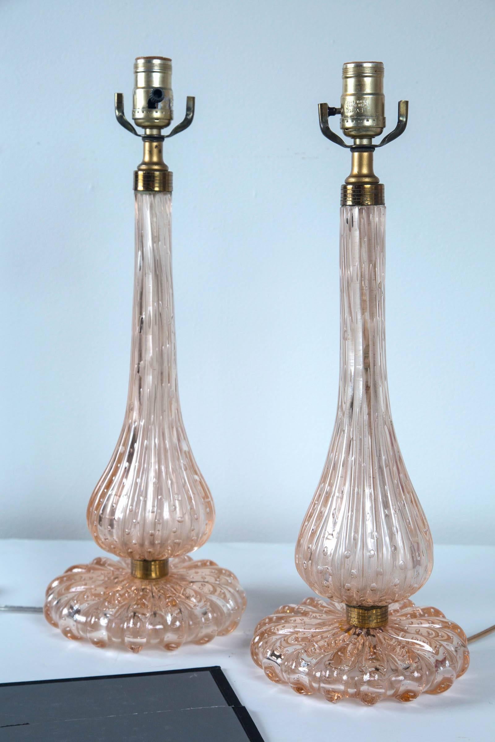 A very fine and rare pair of 1950s Italian Murano lamps in all original condition. Having the iconic internal bubble design with the subtle pastel pinkish color only seen in 1950s Italian art glass designer masterpieces.