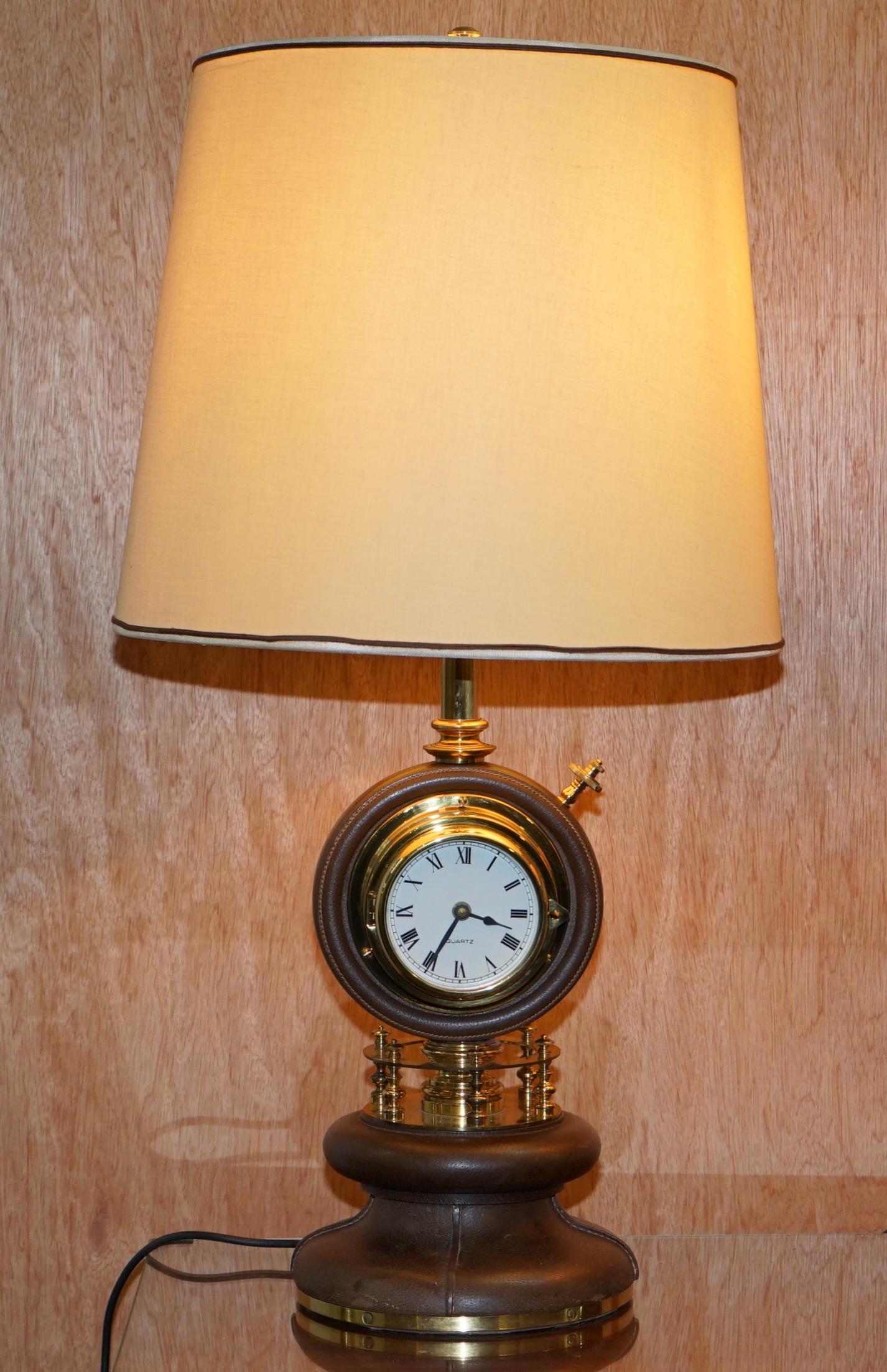 We are delighted to offer for sale this stunning and very rare pair of original 1965 Gucci leather and brass table lamps with revolving clocks and barometers

A highly collectable and well made pair, solid brass with brown leather which has been