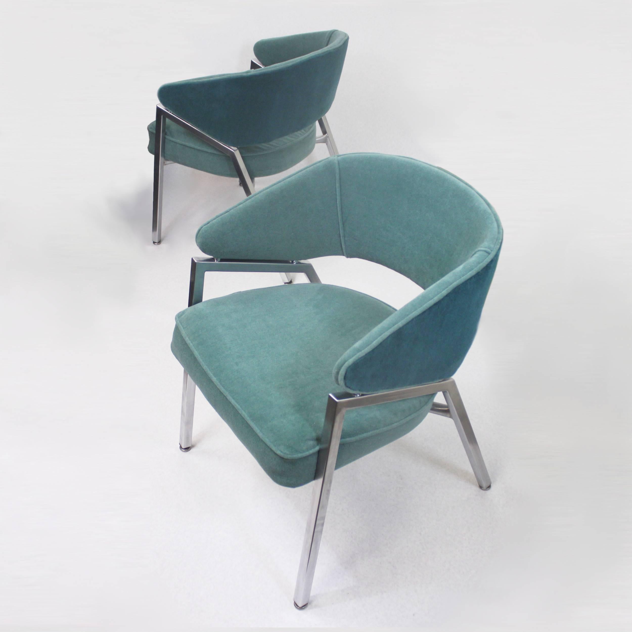This rare pair of chrome side chairs by the Troy Sunshade Co. are fresh off a full restoration with new vintage, teal and green velour upholstery. The floating, two-tone backs are a unique design feature reminiscent of designs by Dutch Architect