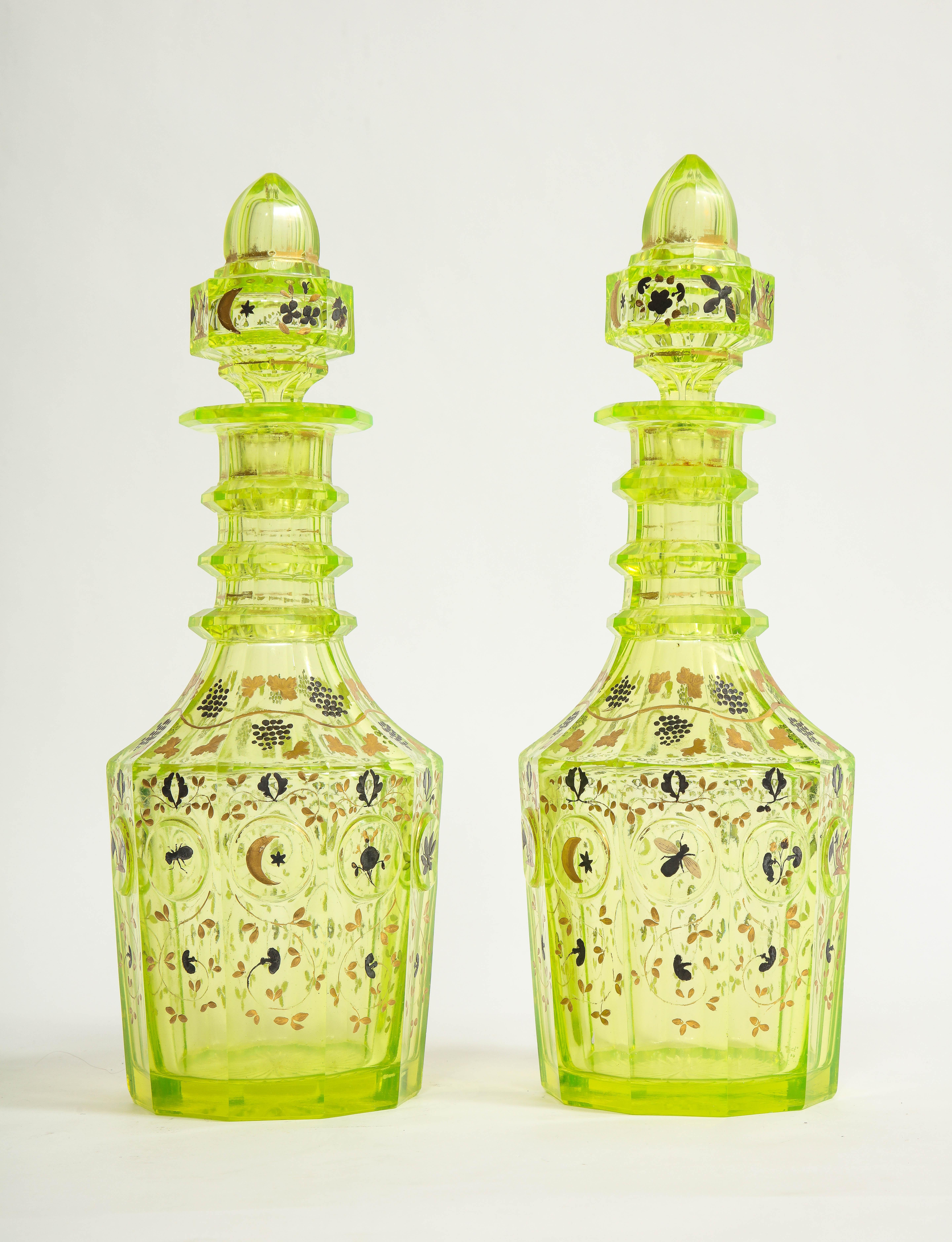 A very rare and impressive pair of 19th century Bohemian cut crystal Uranium color decanters/bottles with gold and platinum hand-painted decoration made for the Turkish/Ottoman market. Each of these decanters is made of the highest quality Bohemian