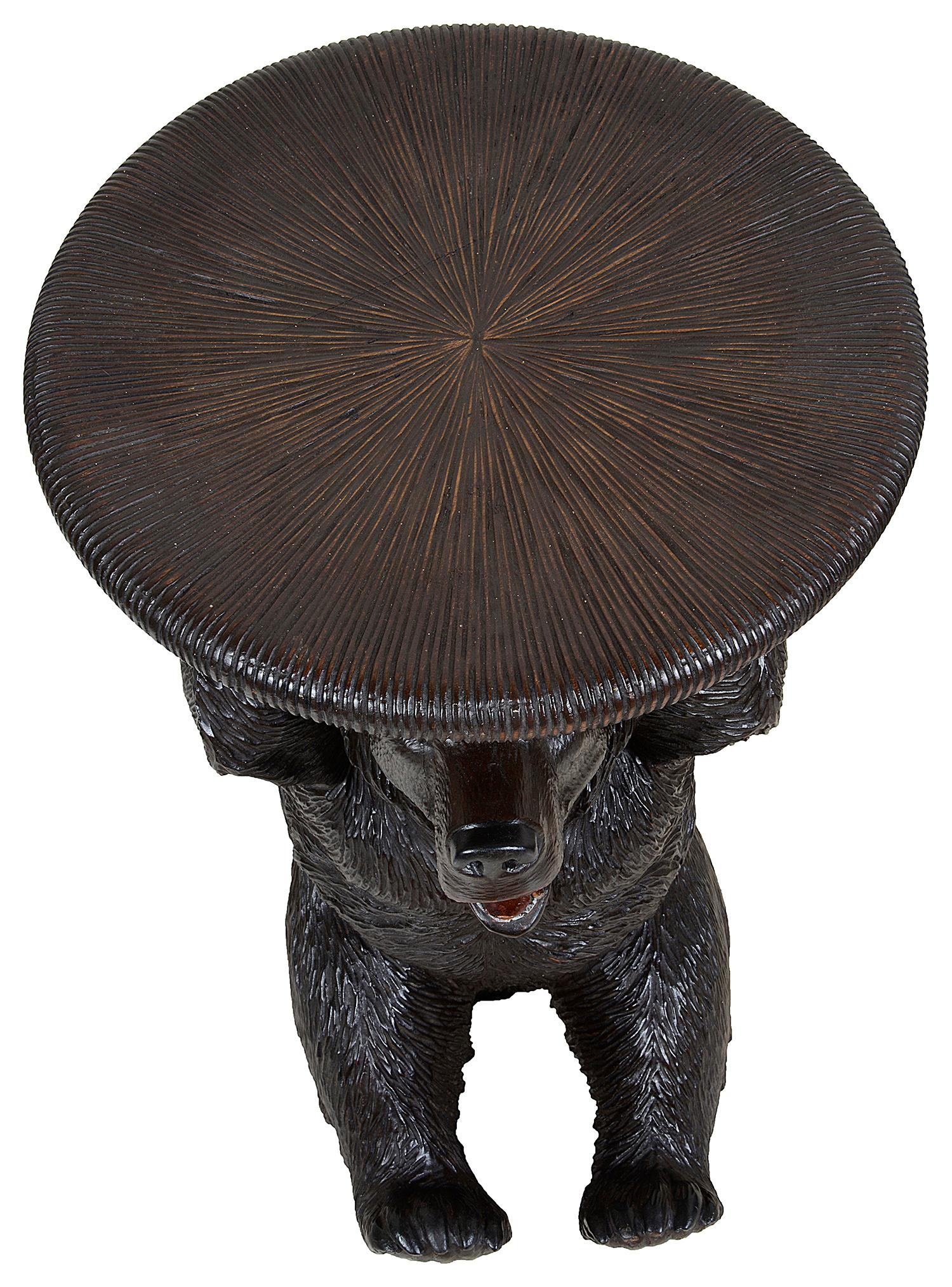 A rare pair of 19th century carved Black Forest stools, each with revolving rising seats, supported by two jovial bears holding tree branches beneath the carved wood seats.