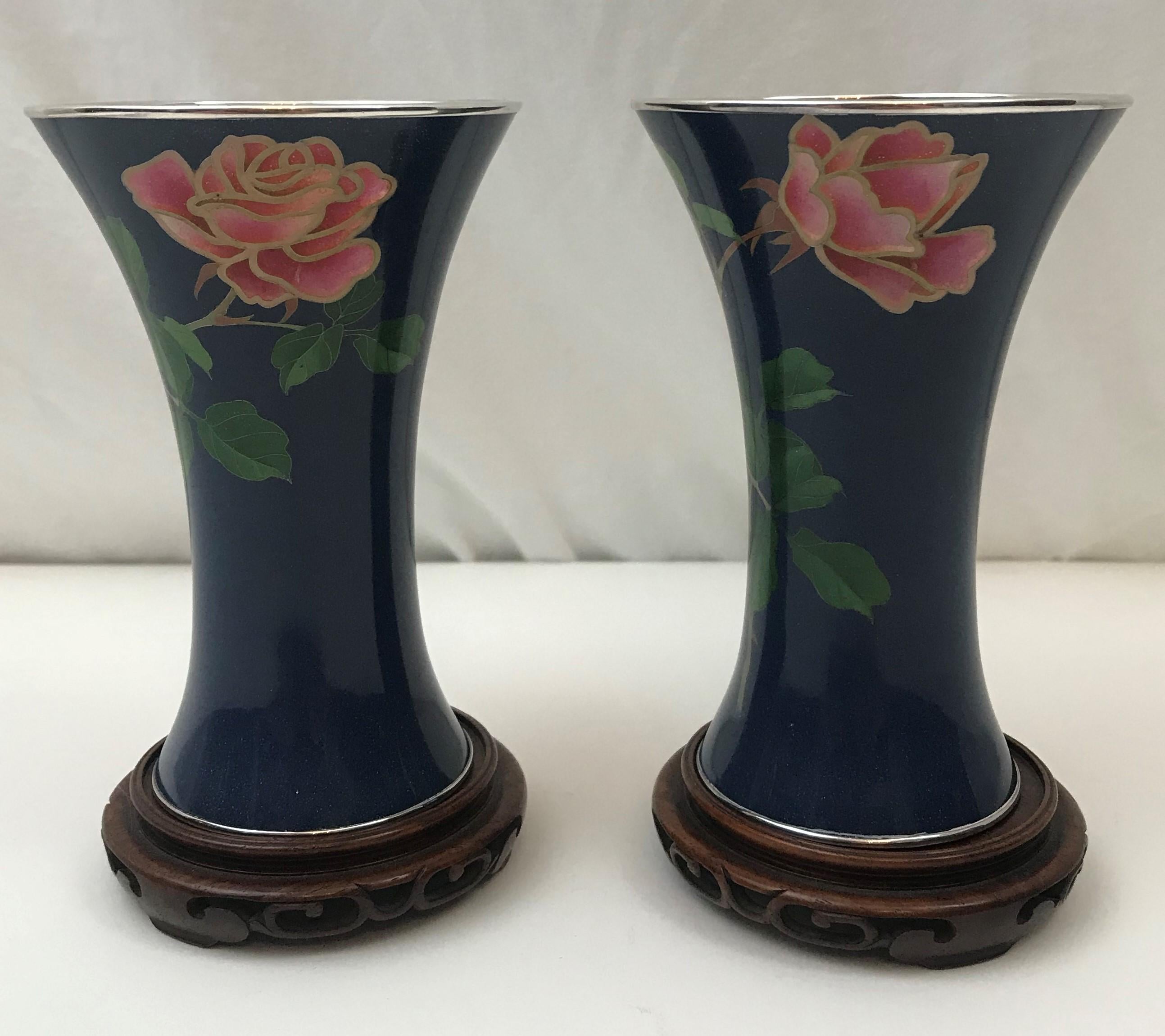 Pair of vases. Japanese wireless cloisonne on silver with plique-a-jour (totai shippo) translucent enamel flowers.

Each vase with the mark of Ando Jubei. The plique a jour process was developed by the Ando Company in the early 20th century.