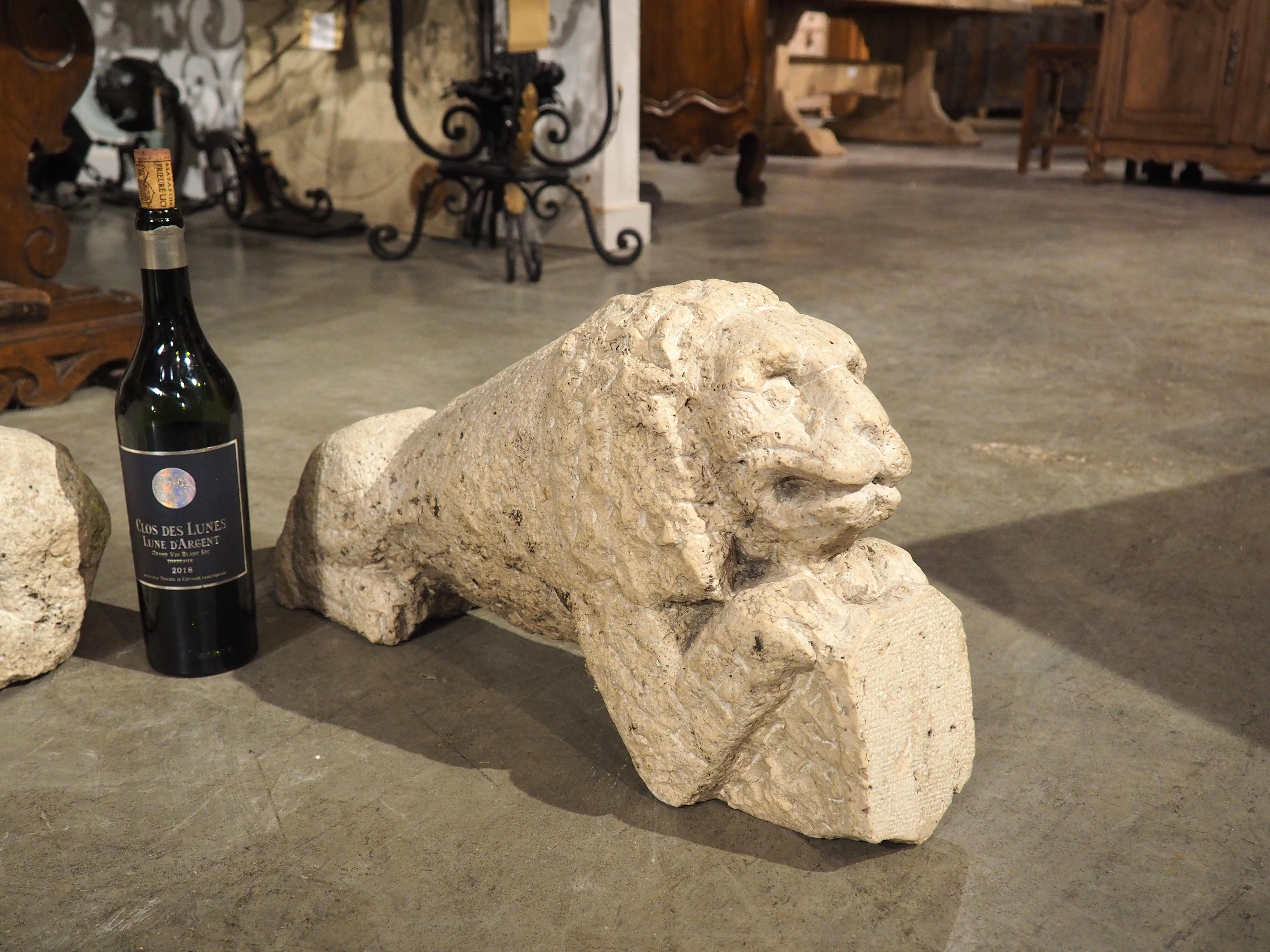 These utterly captivating, hand-carved stone lions hail from Italy and date to circa 1600, possibly even earlier. Their regal couchant (lying down) posture adds an air of majestic charm to any setting. One lion gracefully rests its forepaws on a