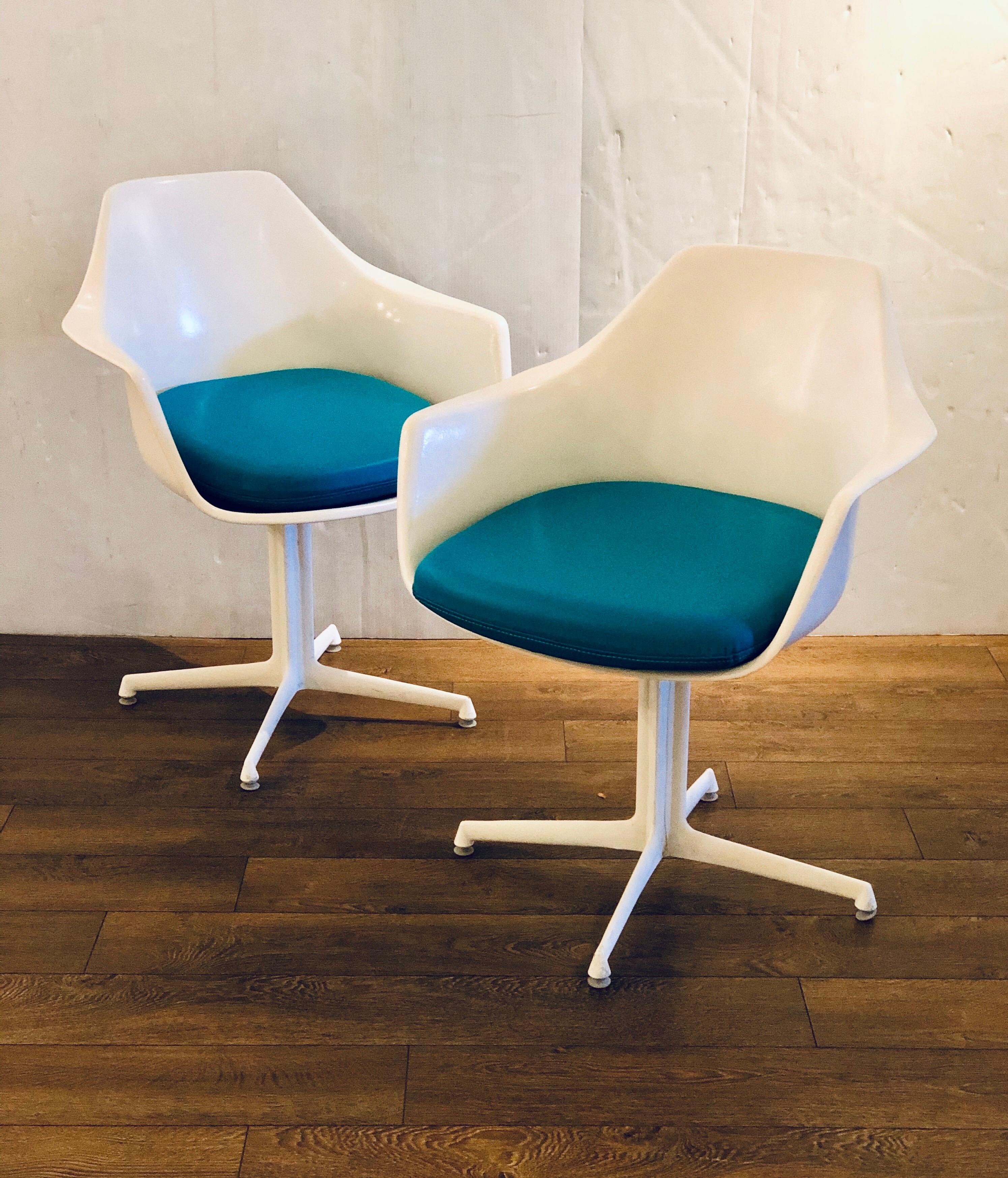 A rare pair of arm swivel chairs designed by Maurice Burke for Burke, Inc. circa 1970s in great condition very clean rare star base, newly upholstered cushions in turquoise Naugahyde, a great example of Space Age era.