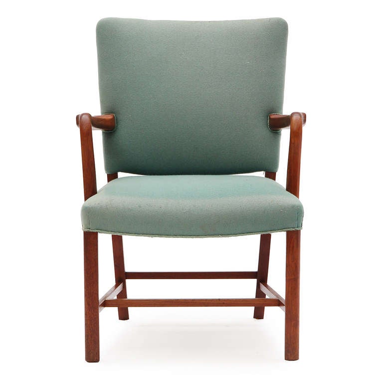 A set of two (2) Scandinavian Modern armchairs by Peter Hvidt & Orla Mølgaard-Nielsen. Solid Cuban mahogany wood with hand-sculpted armrests and upholstered seat and back.
Produced in Denmark, circa 1930s.
