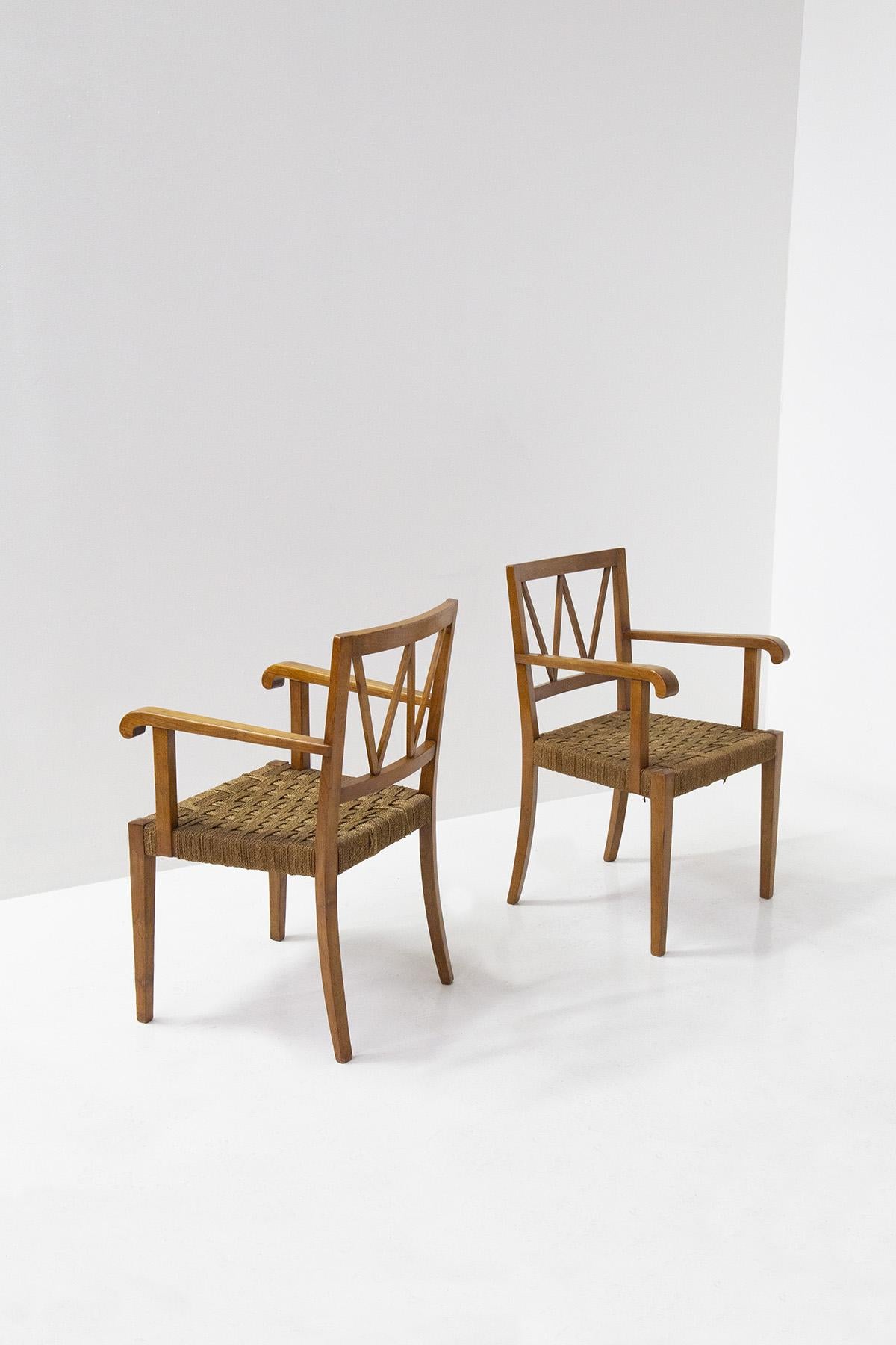 Great and very rare pair of armchairs by Paolo Buffa from the 1950s. The pair of armchairs is made of walnut wood, with elegant geometric markings present in their backs. In fact, the backrests are made with crisscrossed lath rods that form an