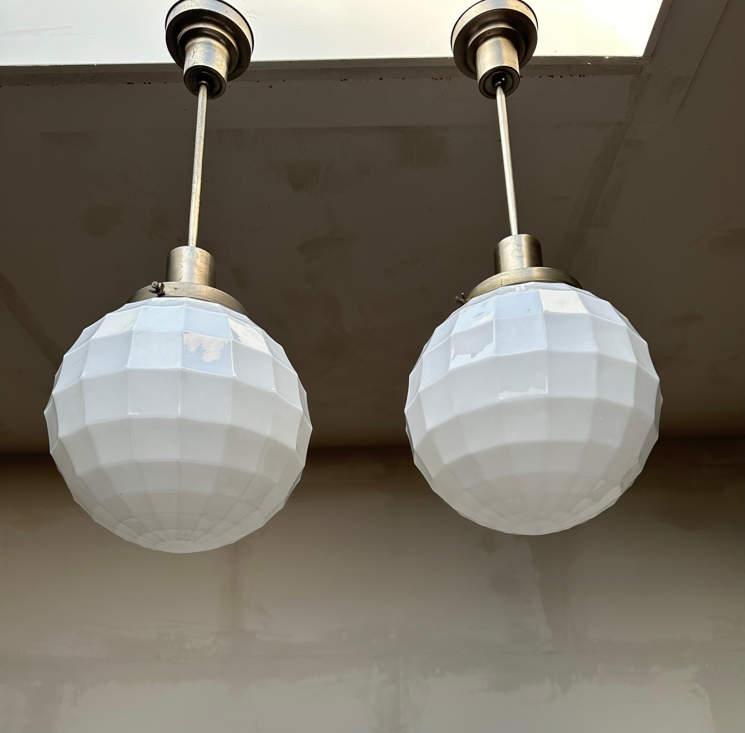 Beautiful shape and excellent condition pendants by Philips, circa 1920.

Finding one rare original light fixture is a good thing, but finding two is always that extra bit special. And when those light fixtures also come with extremely rare, opaline