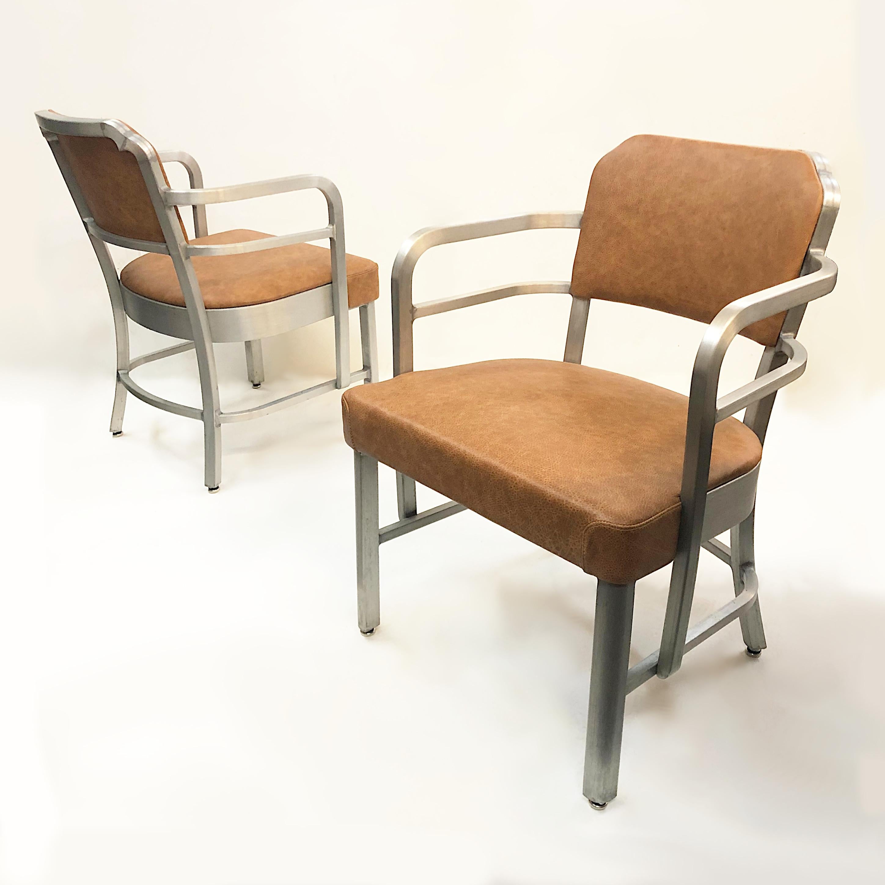 This is a wonderful pair of rare side chairs by the GoodForm/General Fireproofing Company. Chairs feature brushed aluminum frames, new distressed brown leather and fantastic Art-Deco lines. The aluminum and brown leather give these chairs a