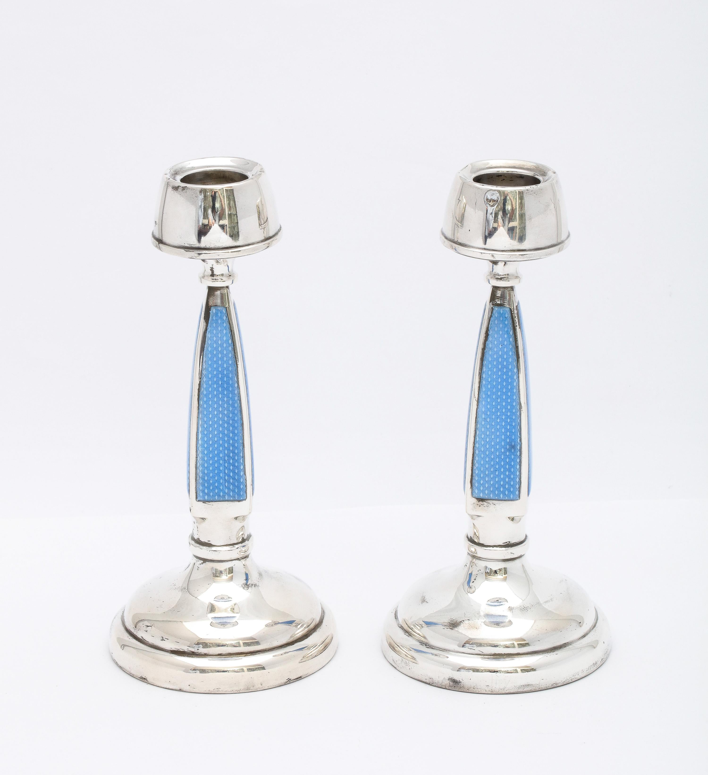 Rare pair of Art Deco, sterling silver and blue guilloche enamel candlesticks, Birmingham, England, year-hallmarked for 1927, A.L. Davenport - maker. The center of each four-sided column of each of the candlesticks is a lovely shade of blue