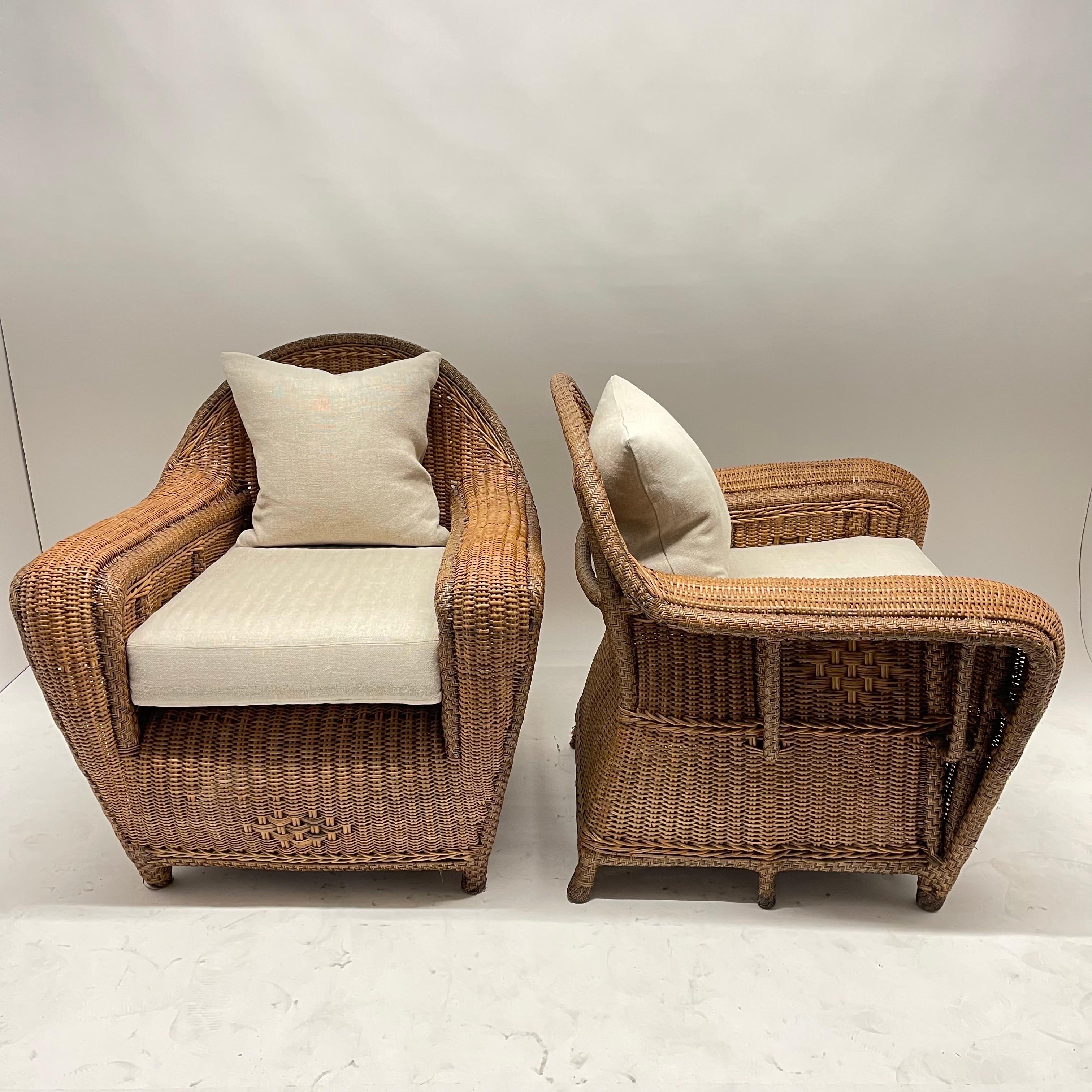 Rare pair of Art Deco wicker and rattan armchairs or club chairs with linen cushions and a down and linen back cushion, circa 1930s