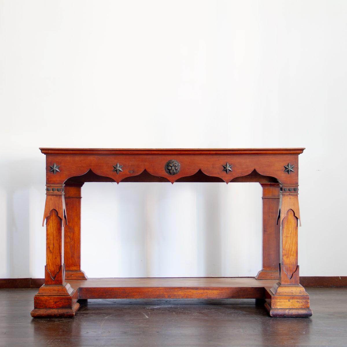 A rare pair of large classical and sophisticated fruitwood console tables from the Baltics with an unusual combination of both neoclassical and NeoGothic influence. Each console has an original inset white marble tops and the fruitwood is adorned