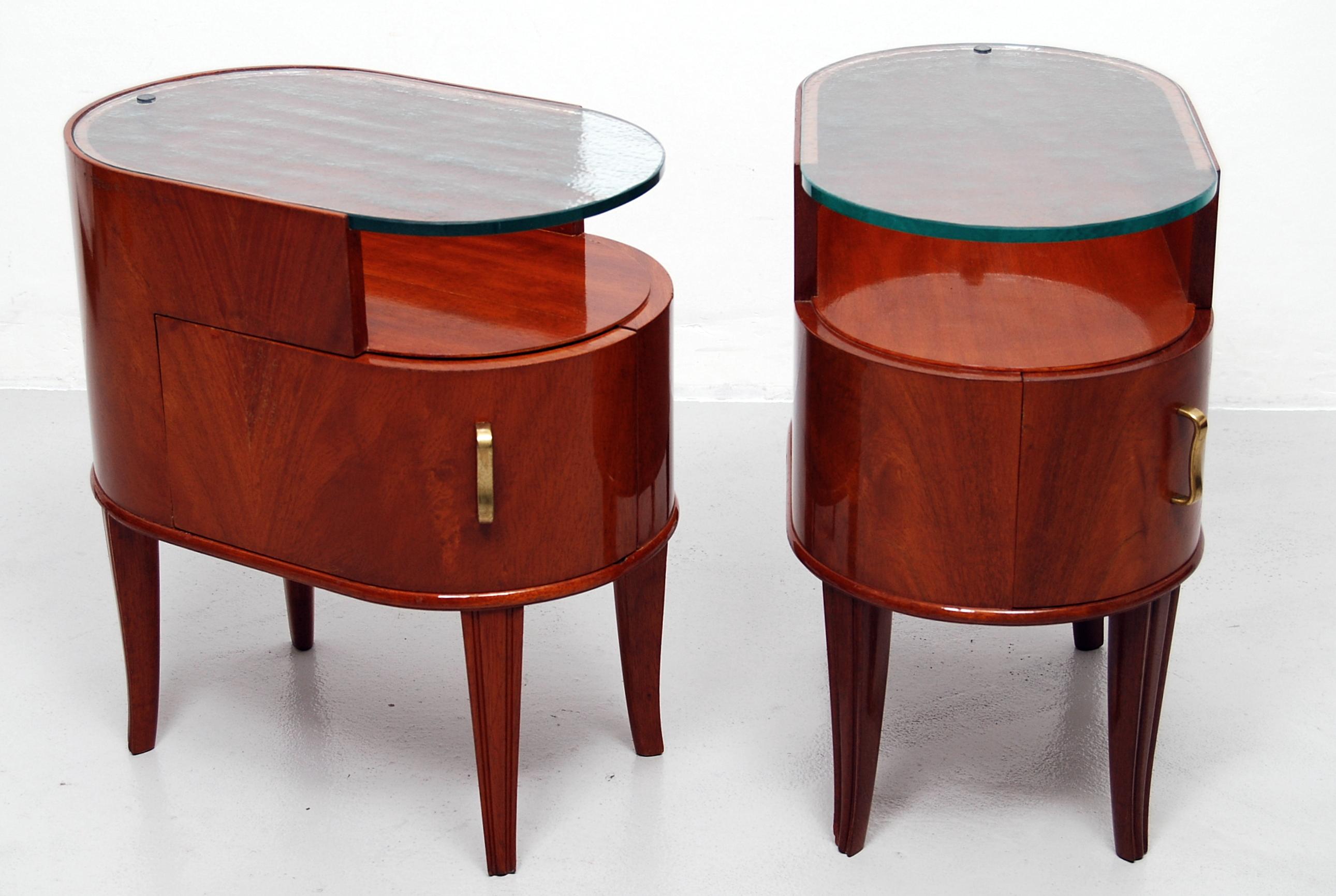 Rare and beautiful pyramid mahogany and glass bedside tables or nightstands designed by Axel Larsson for SMF Bodafors in the 1940s. Thick glass tops with absolute no chips, curved doors with curved, solid brass handles. In good vintage condition