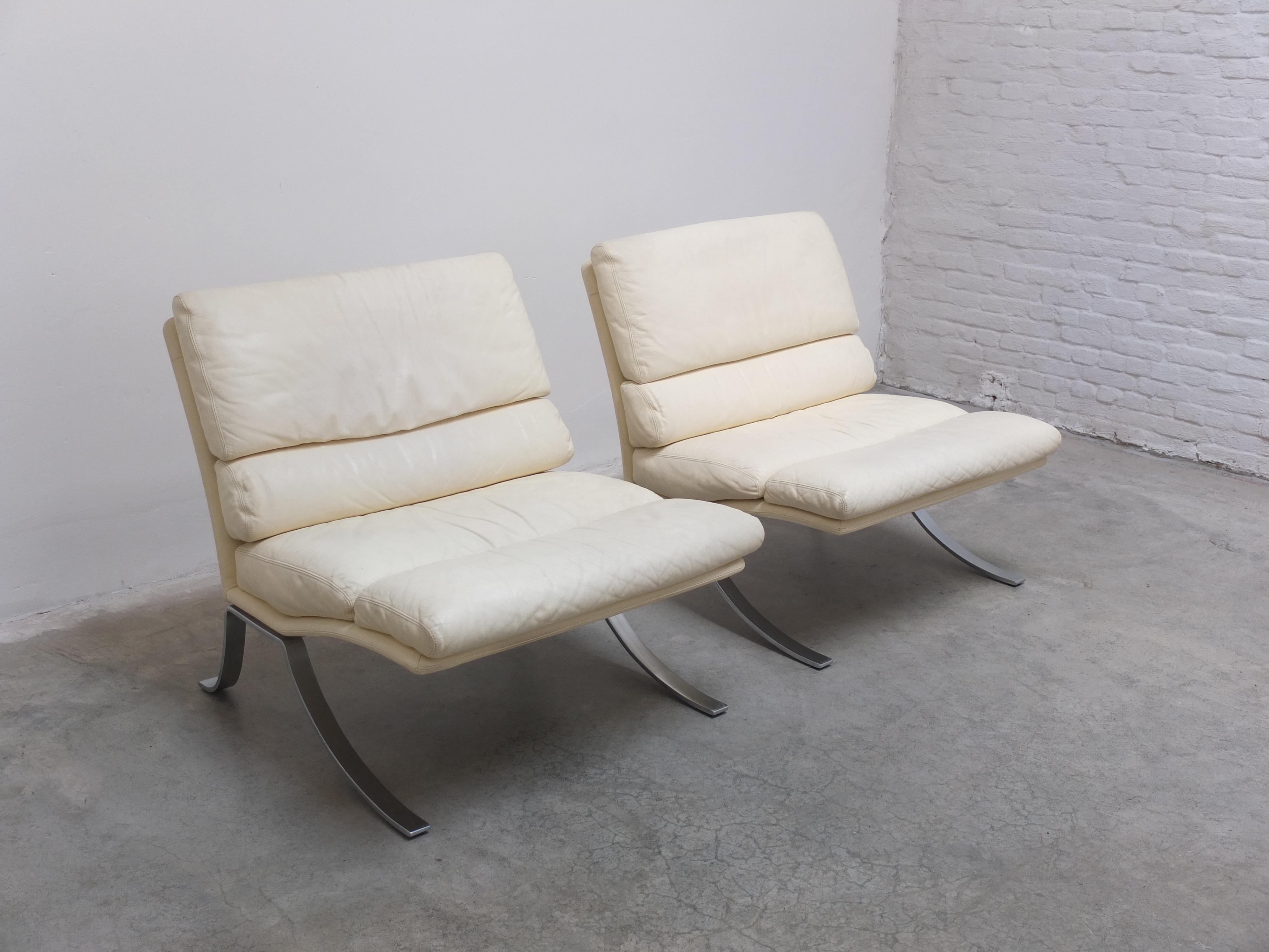Fantastic pair of lounge chairs with ottoman produced by Durlet in Belgium during the 1970s. The seats are made of high quality cream-colored leather and they rest on a beautiful chromed flat steel base with very elegant legs. This pair comes with a