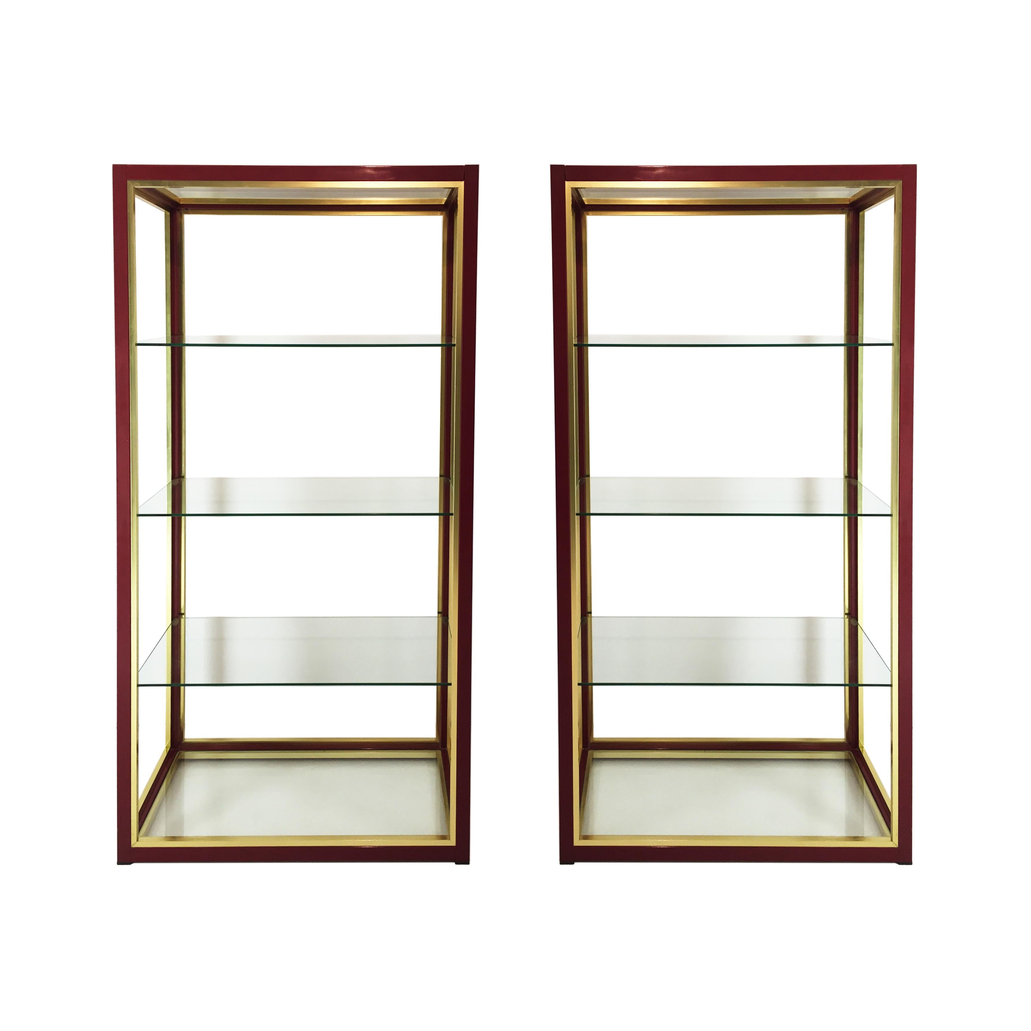 A rare pair of Renato Zevi low étagères in burgundy and gold frame with clear glass shelves. Zevi étagères usually come in chrome or gold frame, the burgundy ones are the rarest ones. Very practical and modern piece either for domestic or commercial