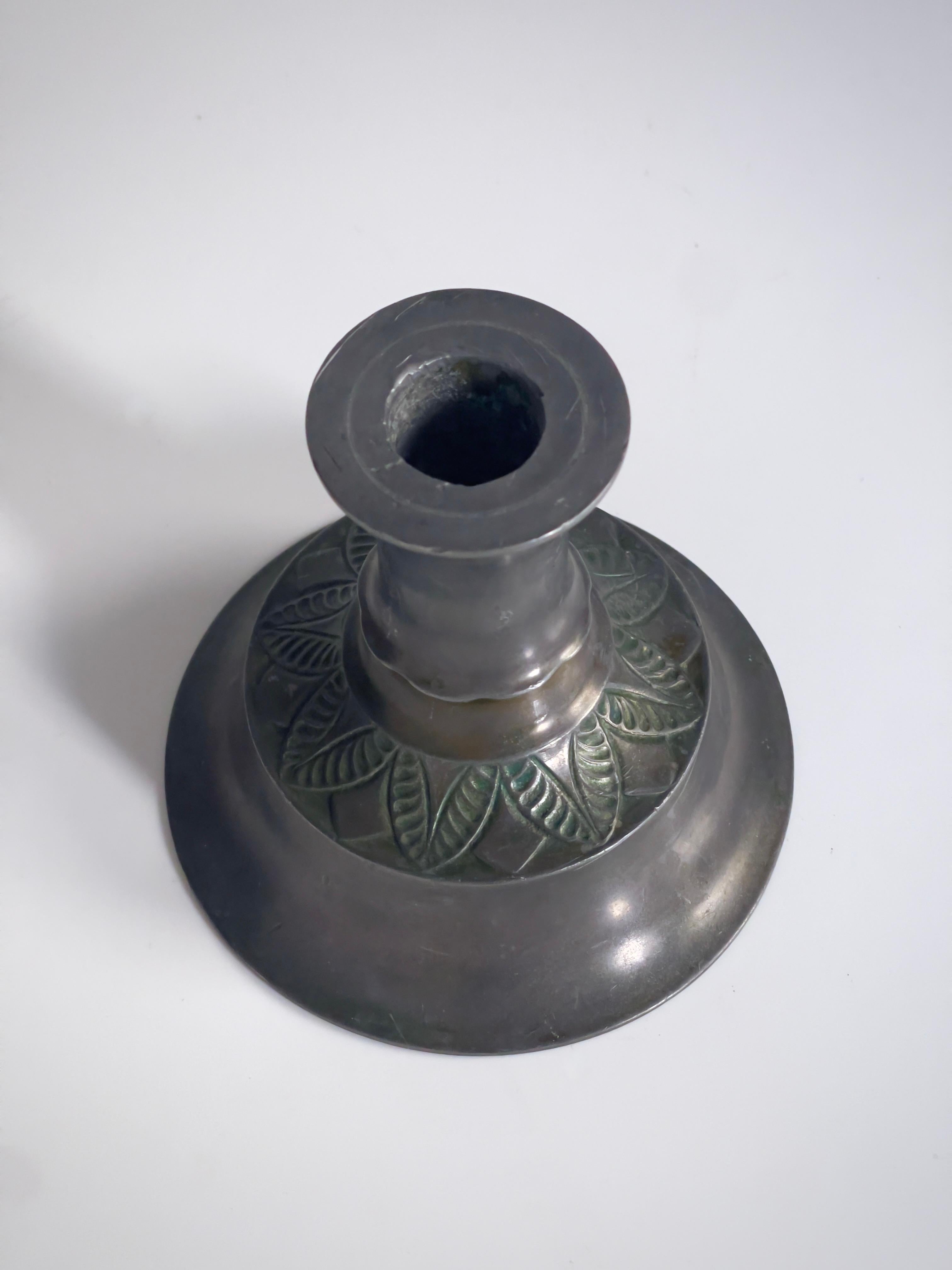 This rare pair of Arts and Crafts candlesticks, crafted by renowned Danish sculptor and silversmith Just Andersen in the 1920s, exemplifies the unique blend of artistry and craftsmanship that defined his work. Known for his innovative use of