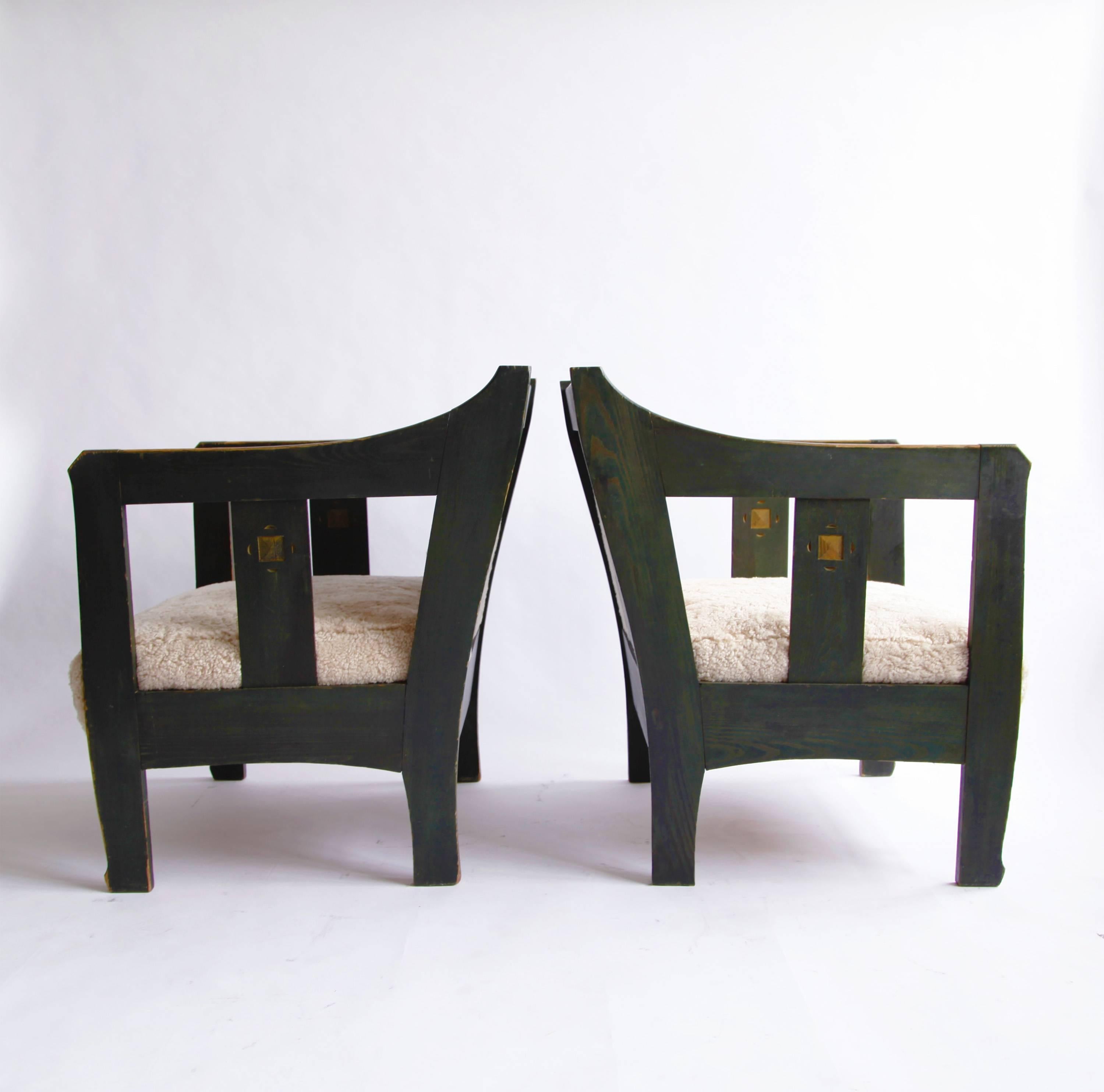 A pair of handsome armchairs, the wood stained a faded forest green, the seat and back upholstered in Swedish shearling. 

Carl Westman, a designer of furniture and interiors, was foremost an architect--one of the first in Sweden to implement a