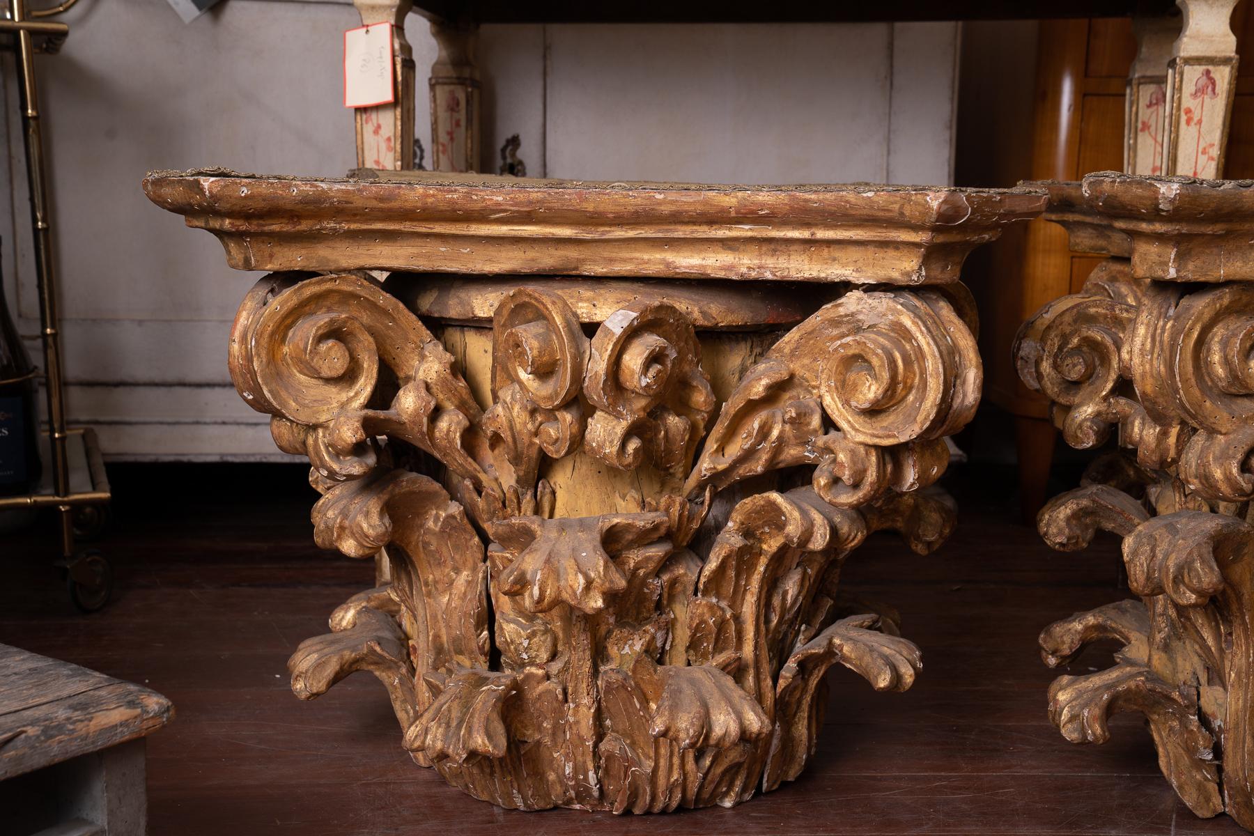 A very rare pair of carved and gilded wooden capitals-perfect height for coffee table.