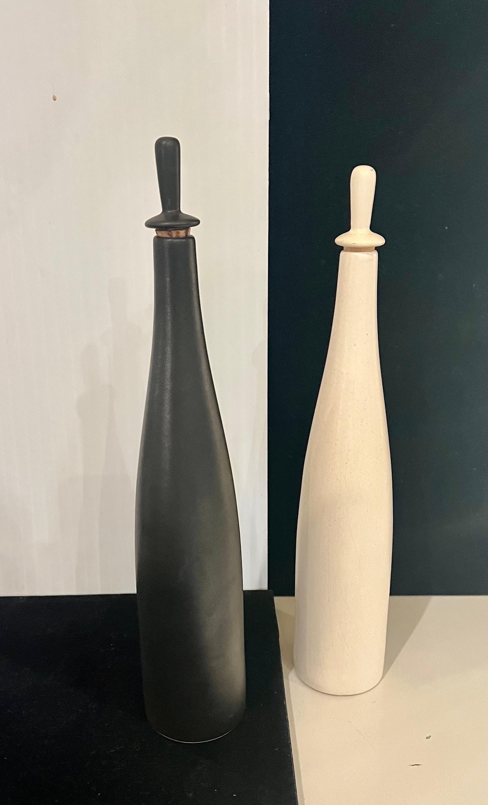 Beautiful and rare pair of tall ceramic bottles designed by Evelyn and Jerome Ackerman for Jenev Designs, an early and rare-to-find set signed and labeled in black and white with no chips or cracks.