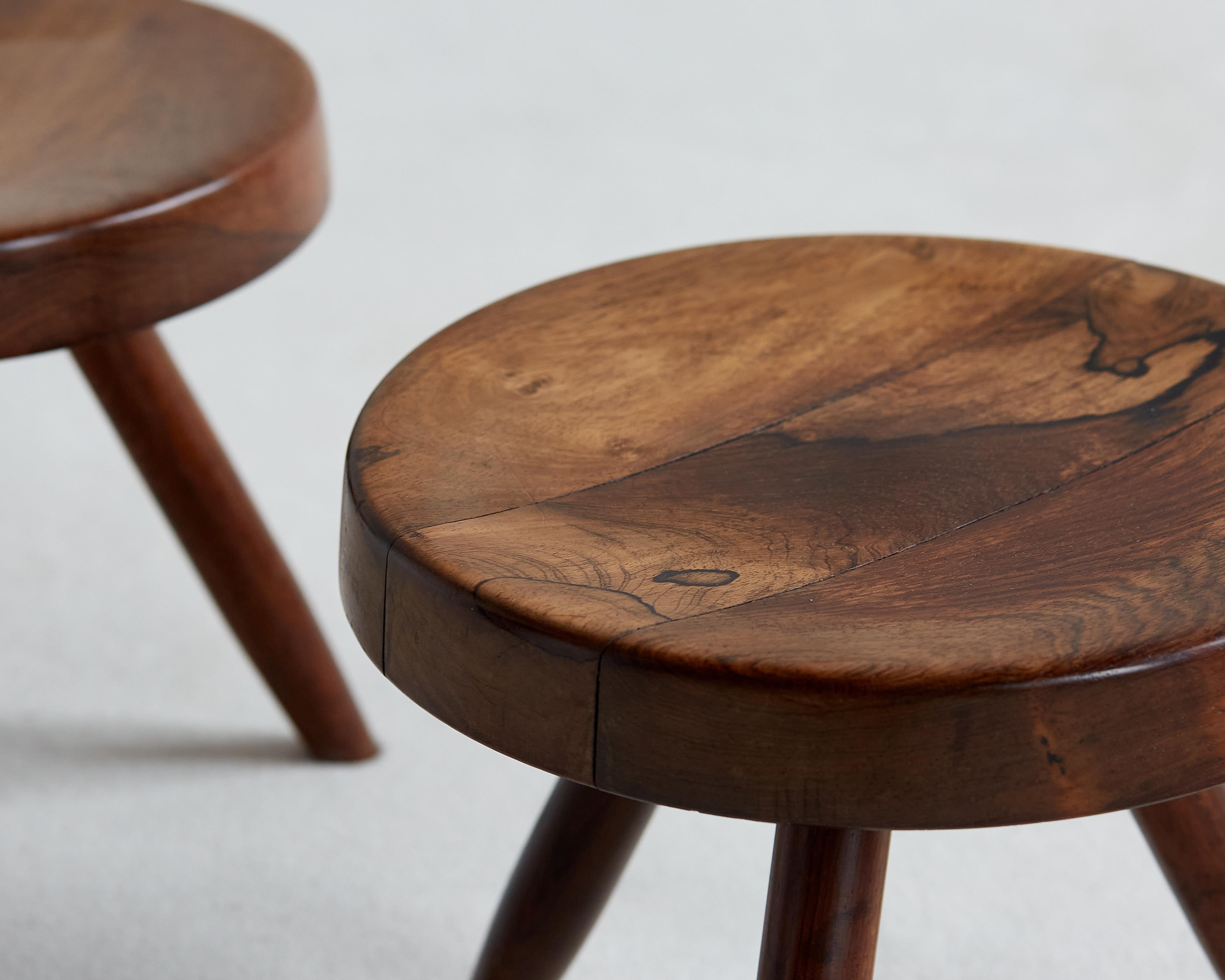 A rare pair of Charlotte Perriand Berger stools in Jacaranda, a Brazilian rosewood. There are very few of these stools in existence in jacaranda. 

Provenance: Acquired directly from the artist, circa 1970s; Private Collection, Rio de Janeiro;