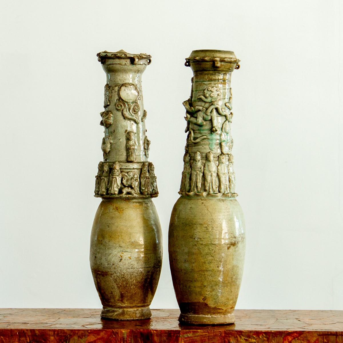 A rare pair of Chinese Song dynasty, Qingbai funerary earthenware vases, highly decorated with a band of attendant figures, dragons and animals to the neck of the tall vases.

These vases have a lovely green glaze with dark green streaks.

The