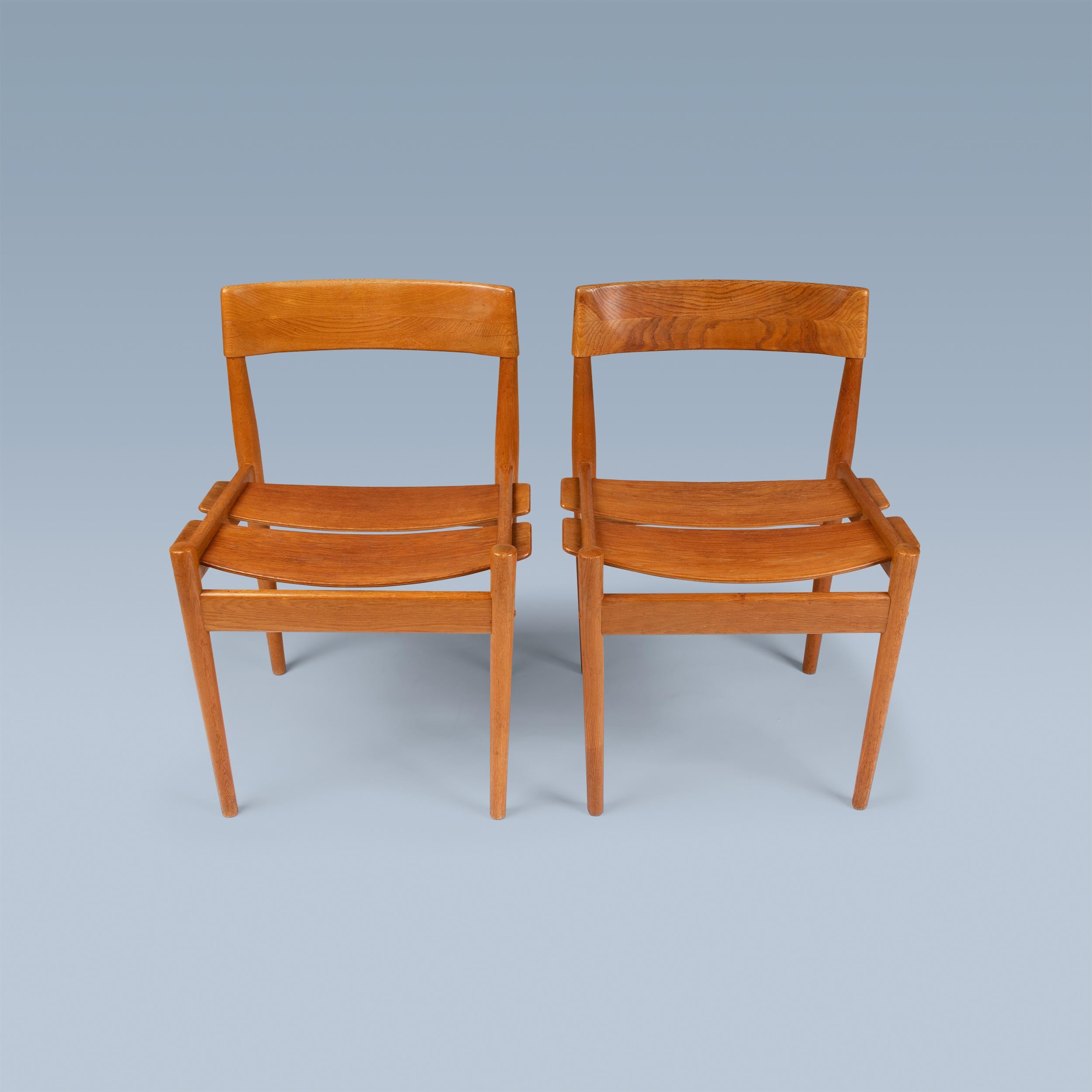 This rarely seen pair of side chairs (model 3-1) in slightly fumed oak was
designed ca. 1956 by Danish designer Grete Jalk (1920-2006). These examples were executed by Poul Jeppesen, Denmark in the late 1950s. 

One chair labelled P. Jeppesen
