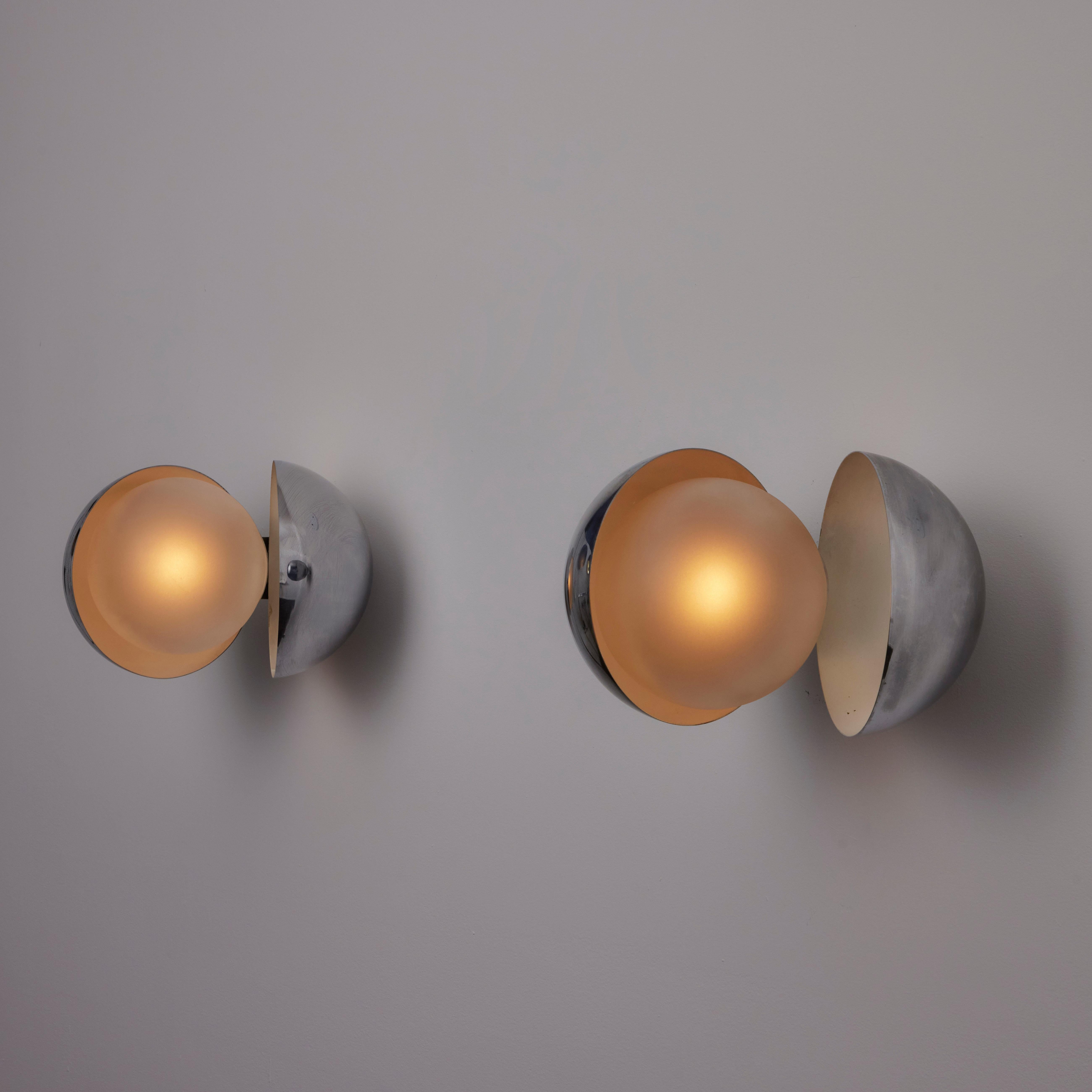 Rare pair of Diaframma Sconces by: G. Piero & A. Monti for Fontana Arte. Designed and manufactured in Italy, circa 1960's. Butterfly sconces consisting of a chrome outer shell and clear etched glass globes. You are able to open and close the outer