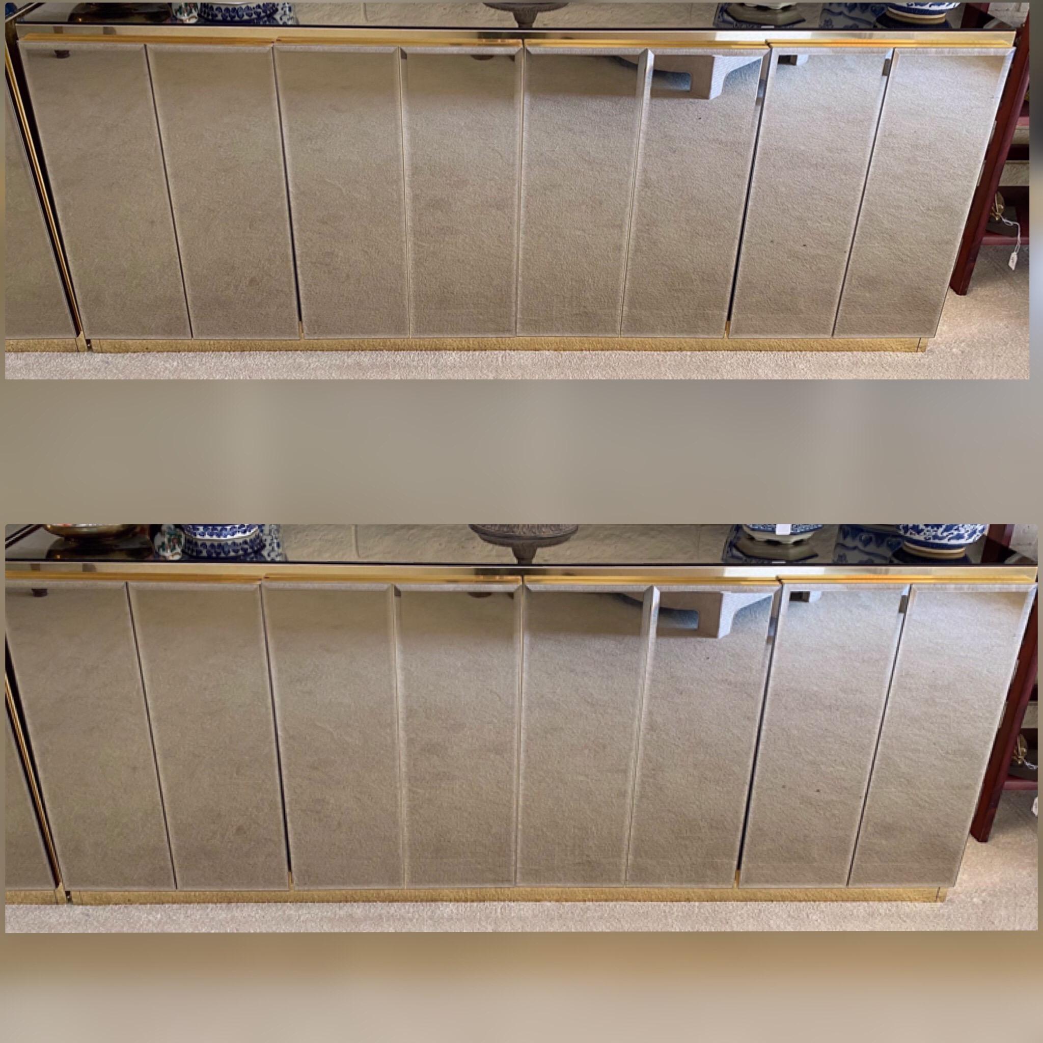 These rare pair of sideboards/credenzas were made in the 1980s by Ello and are in amazing original condition. Made of mirror and brass they are both glamorous and modern. Double cabinets in each piece.