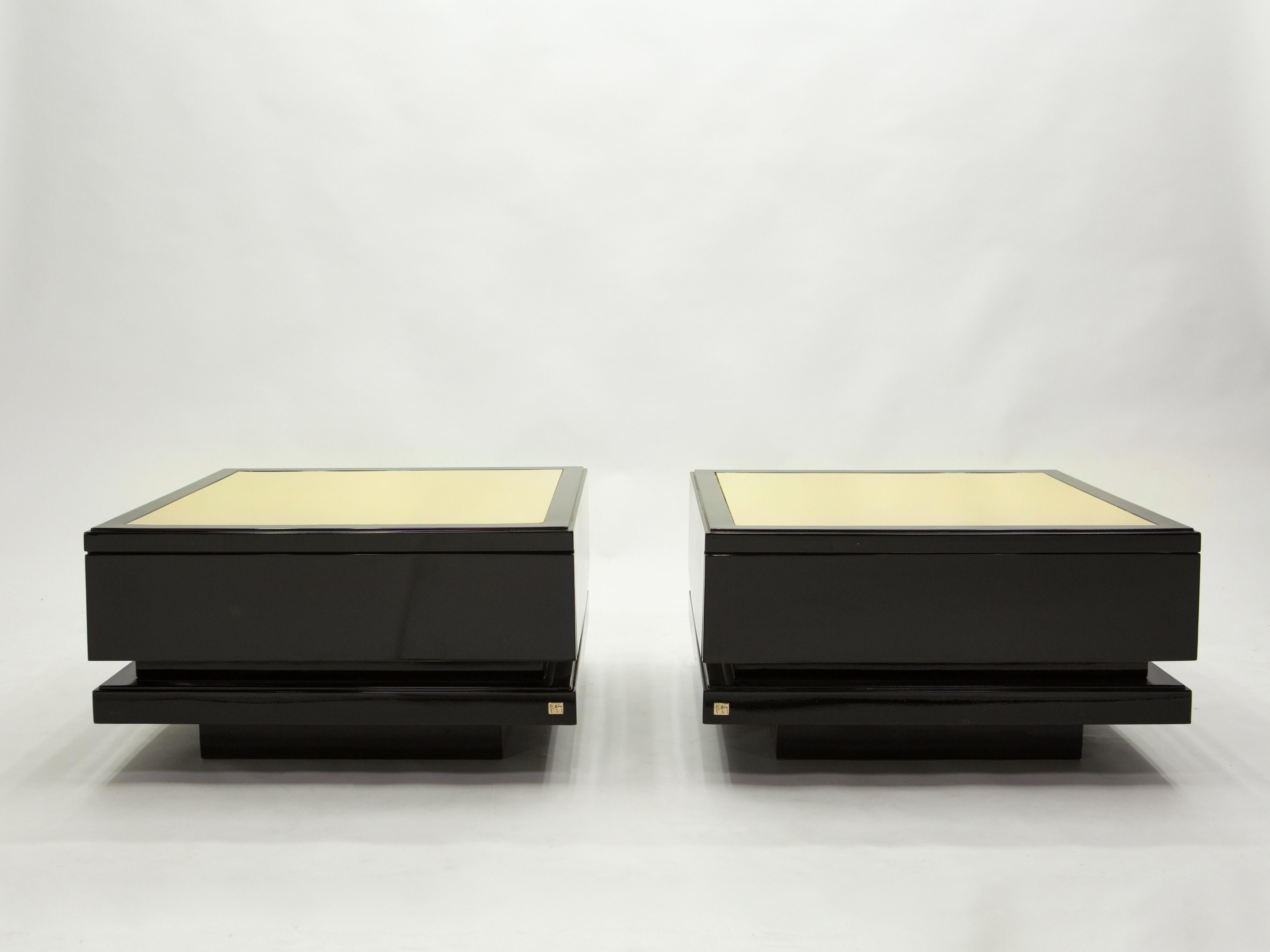 A rare pair of vintage Jean-Claude Mahey for Romeo Paris end tables made in France in the 1970s. Glossy black lacquer, paired with bright brass tops feels crisp and luxe. Each table features one large drawer. Ideal as a large pair of end tables, or