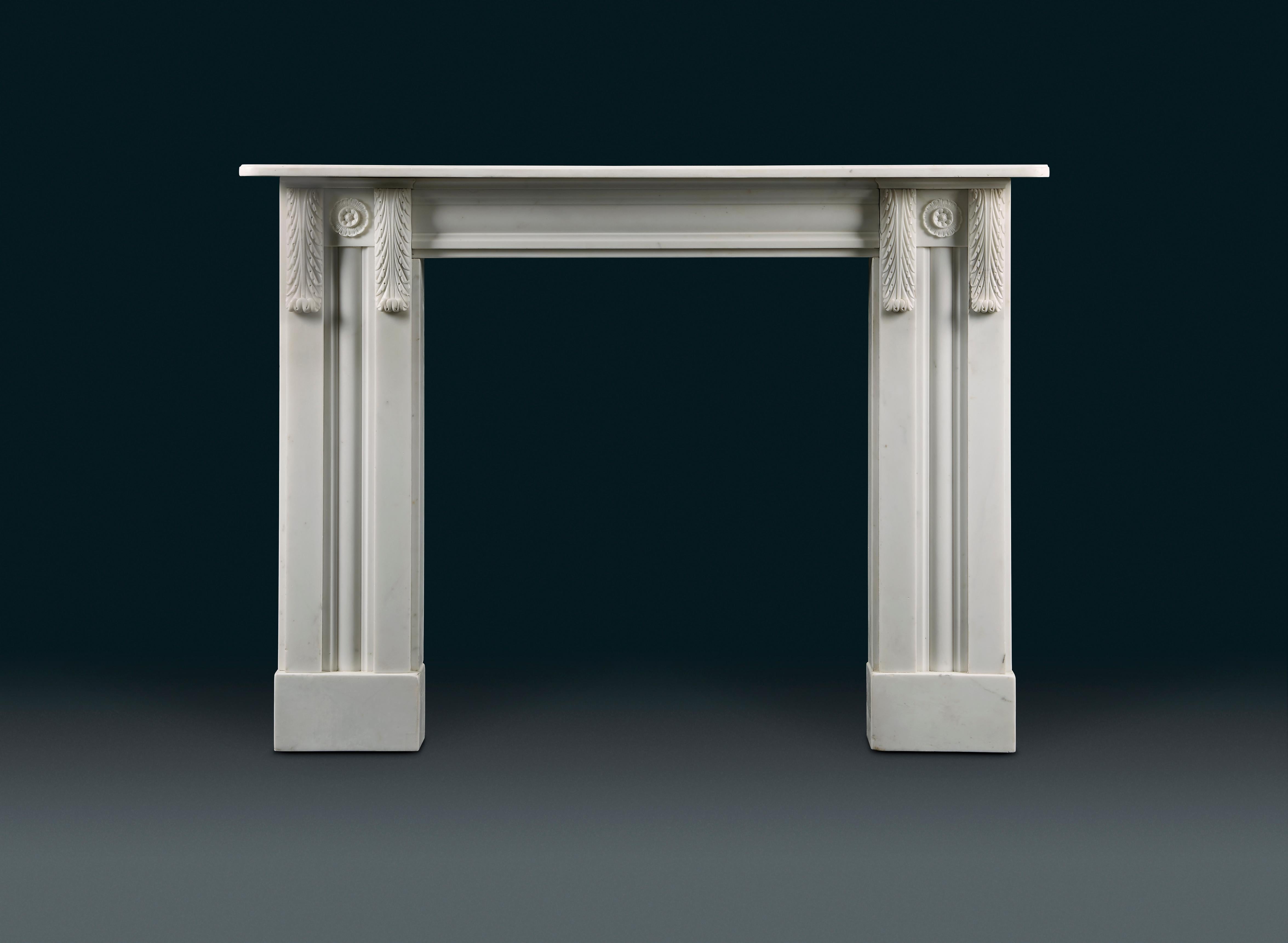 A rare pair of English, late Regency, statuary marble fireplaces. With simple rectangular shelves with rounded corners and ogee edges sitting directly on the inset panelled pulvinated frieze. The jambs with pairs of pilasters capped with acanthus
