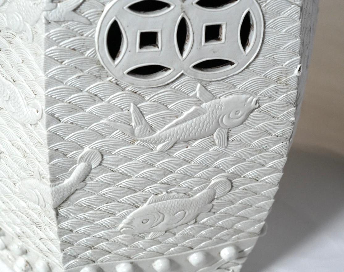 Superb, finely carved off-white porcelain stools with fish swimming in the decorated waves.