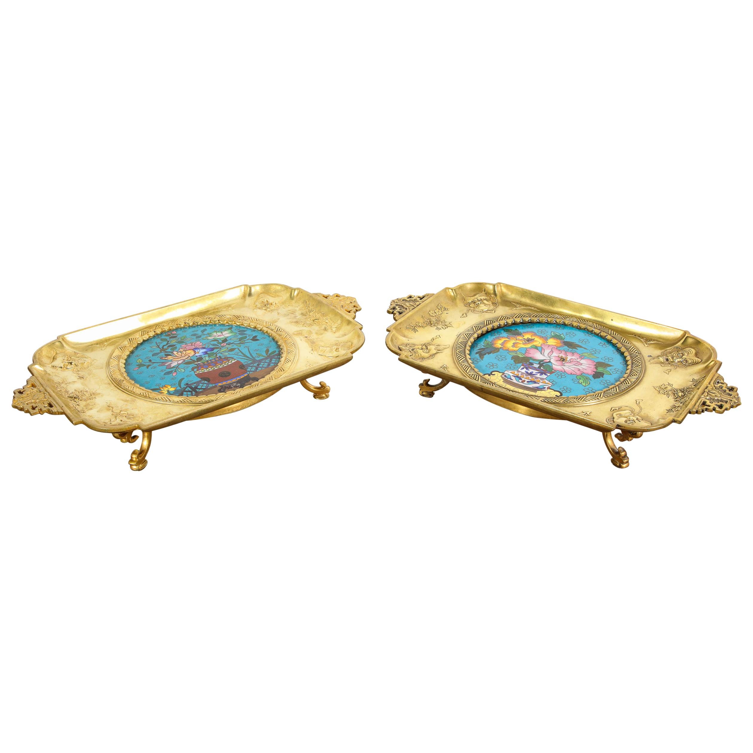 A rare pair of French Japonisme ormolu/bronze and Cloisonne enamel trays attributed to Edouard Lièvre,
late 19th century.

With cloisonne enamel medallions depicting bouquets of flower.

Very finely cast with masks.

Each measures: 3 in. H x