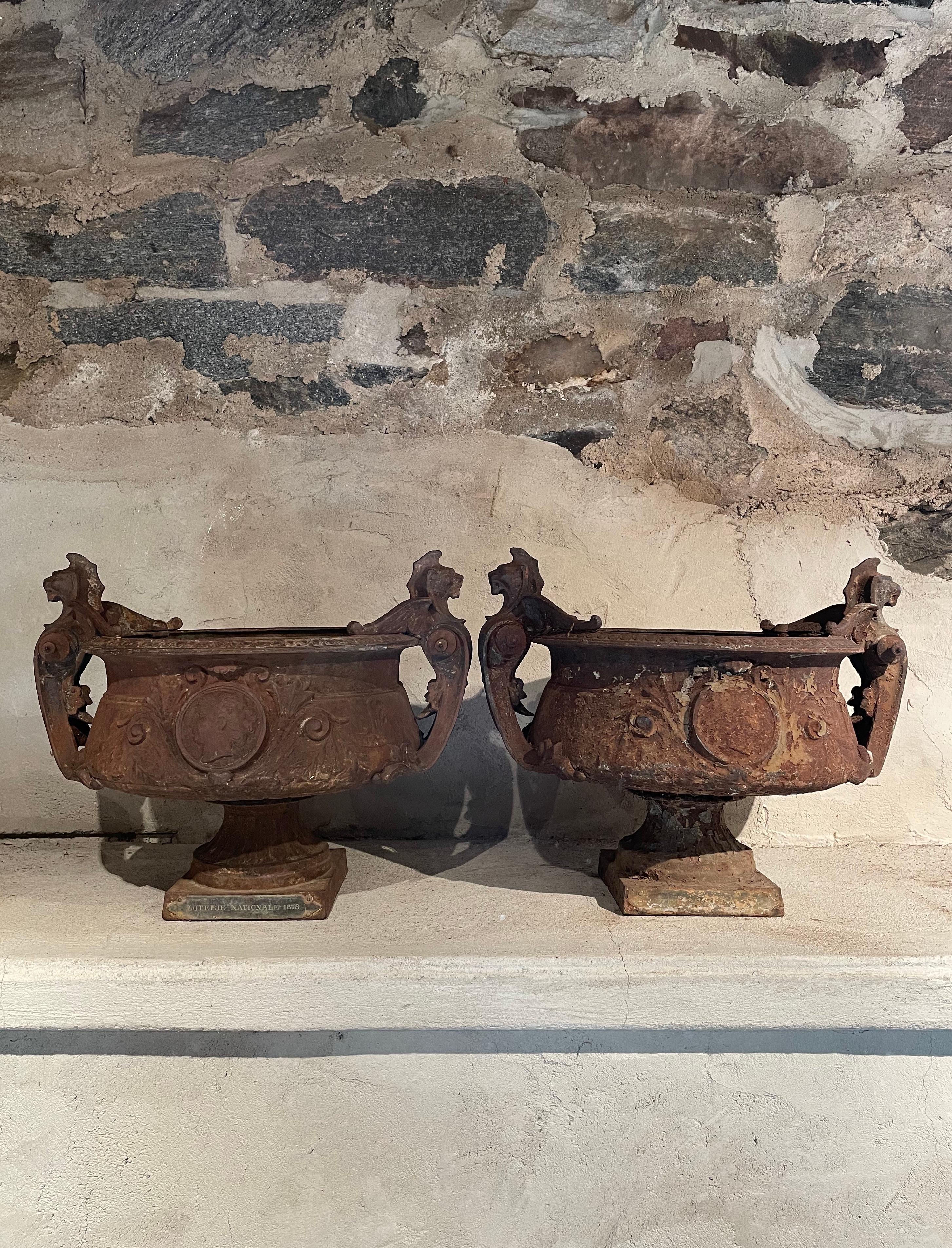 We have never come across this model of urn before and they are simply wonderful! Featuring winged griffin handles riveted to the squat bodies of the urns, the bowls have central medallions of “Marianne,” the iconic emblem of France and elegant