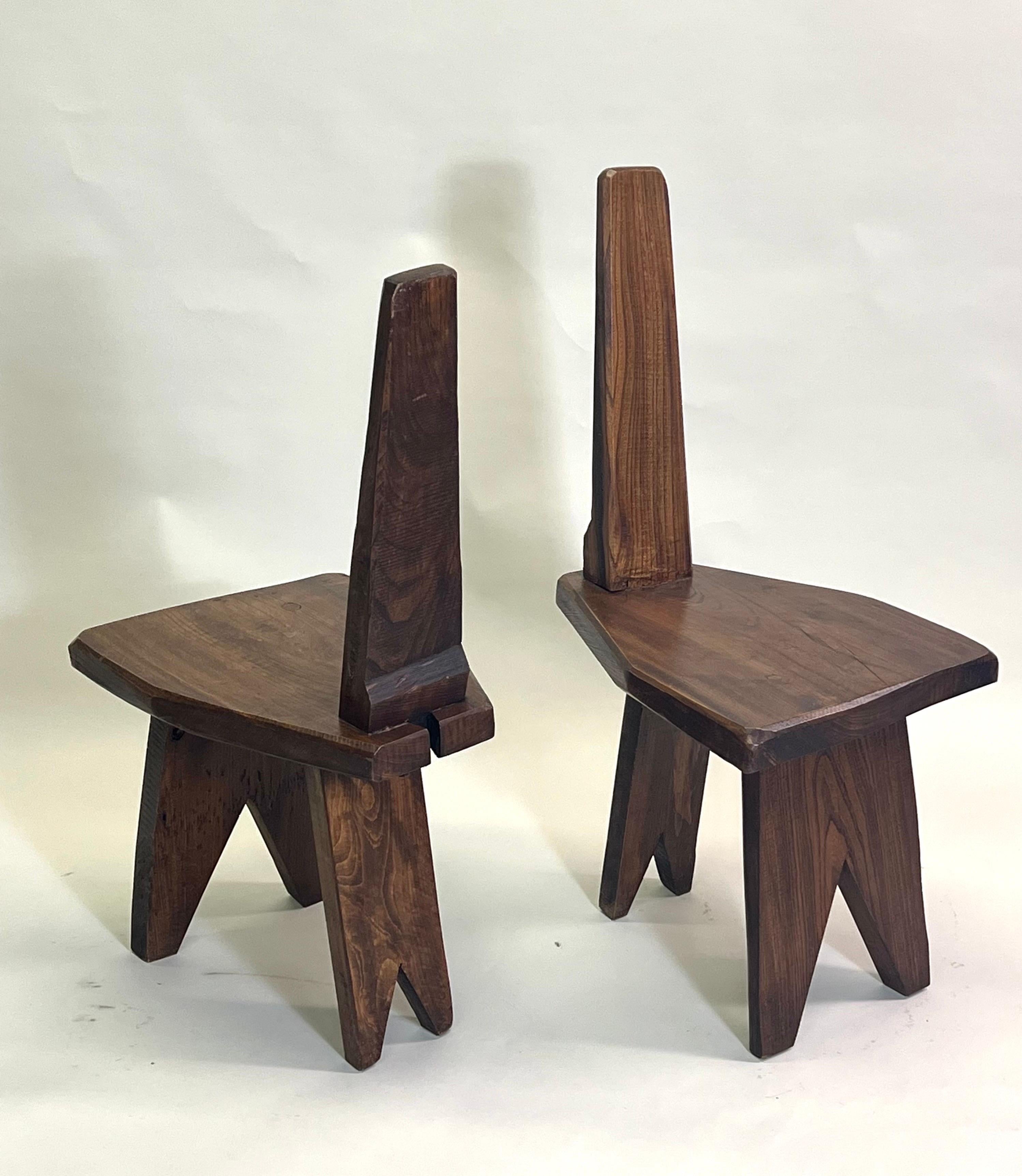 An Elegant Pair of French Mid-Century Modern Craftsman Side or Lounge Chairs in the style of Pierre Jeanneret. The chairs are an original, handmade creation from the 1960 - 1970 period in France. They possess a singular sense of form, line and
