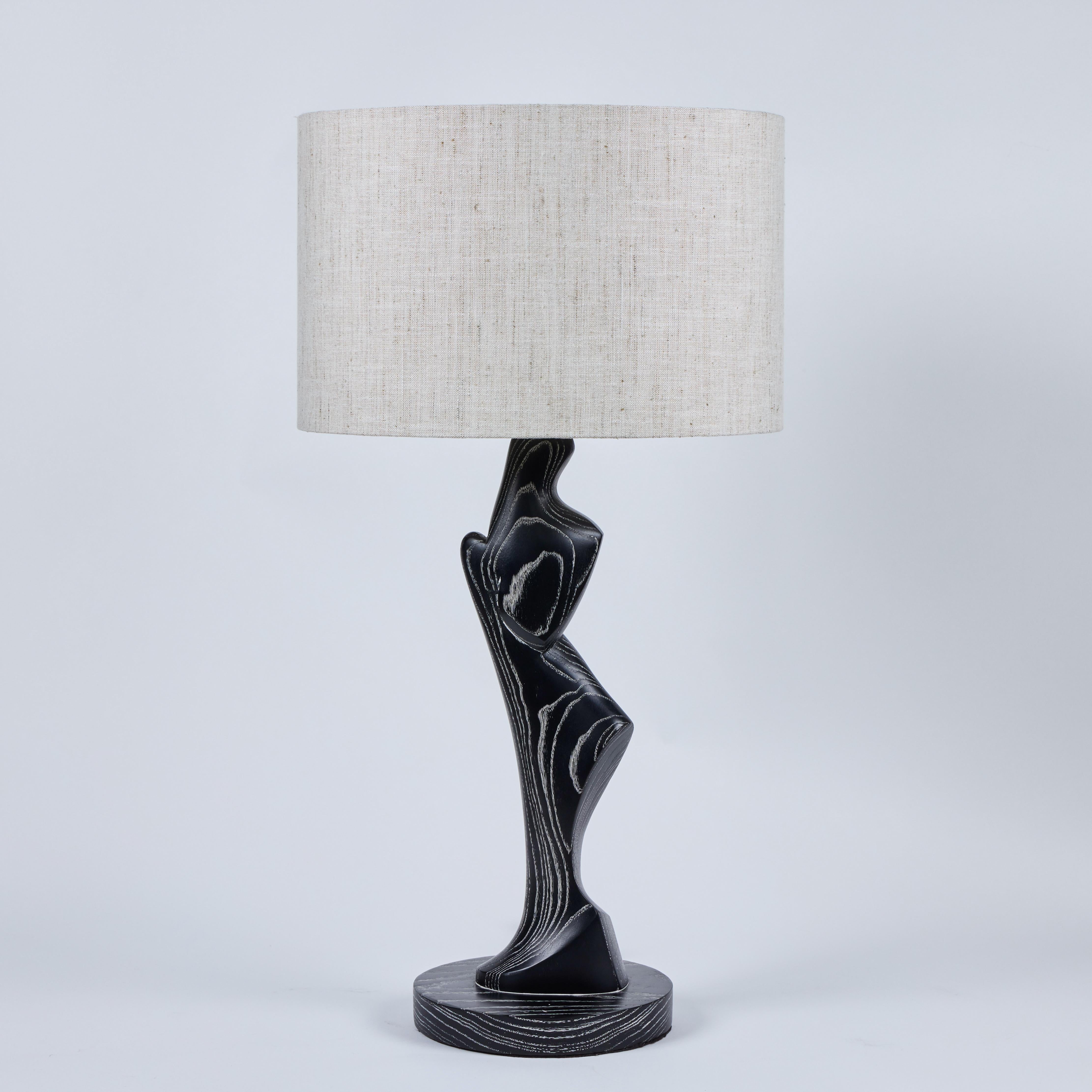 Wonderful pair of highly sculptural lamps of cerused oak.  Exhibiting a somewhat primitive, yet modern aesthetic, the lamps are striking in nature.  Lamps have been newly rewired.  New, custom lampshades of slubby, natural color linen are available