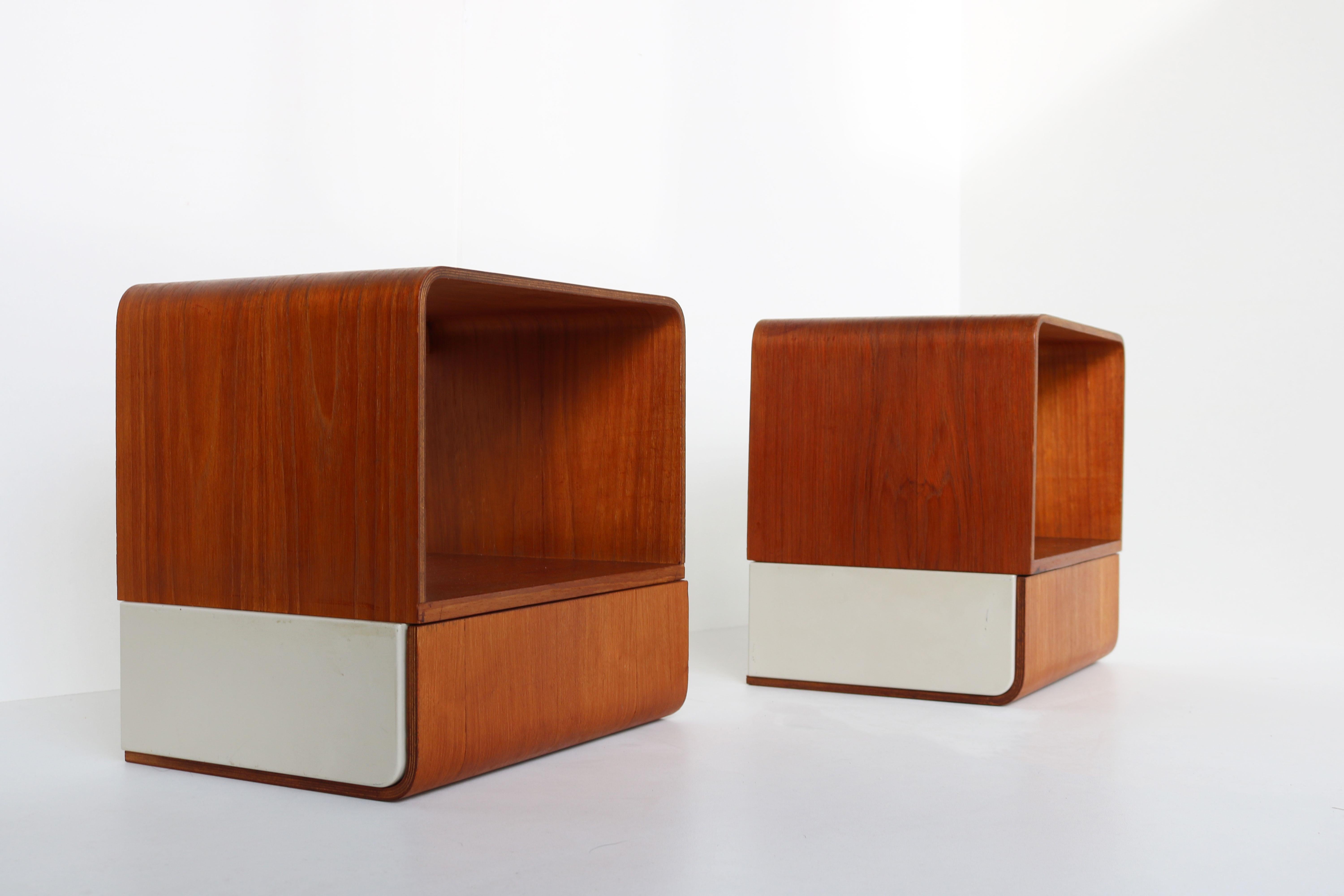 Rare pair of Dutch Design bed cabinets from the ''Euroika Series'' Designed by Friso Kramer for Auping 1963. Wonderful example of Minimalist modernist design with curved teak and white metal. Both cabinets have a drawer and are in great vintage