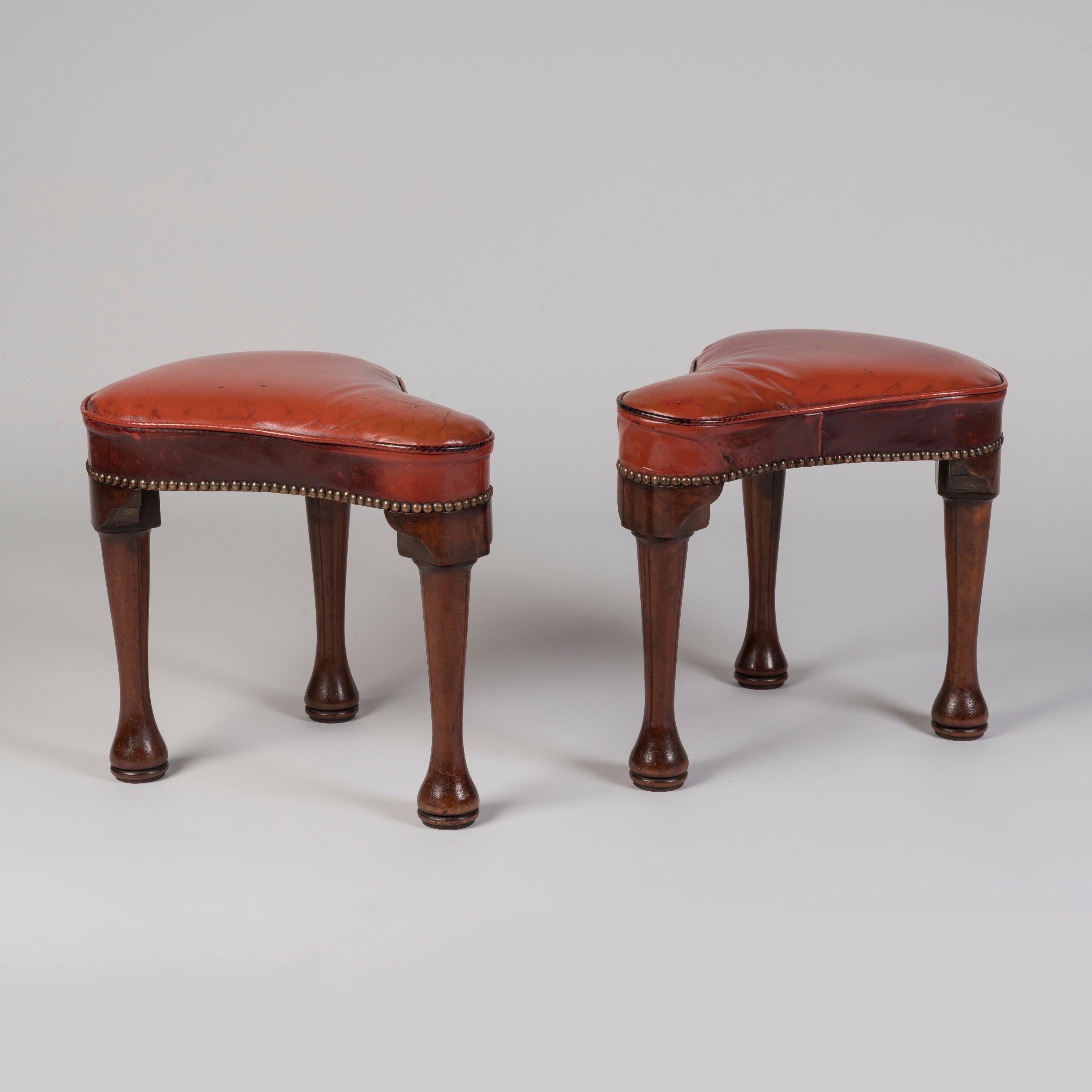 An Unusual George II Period Pair of Saddle-Shaped Stools

The George II period tear-drop shaped stools made from mahogany, the red leather upholstered seats supported on three turned and tapering legs with pad feet.
English, circa