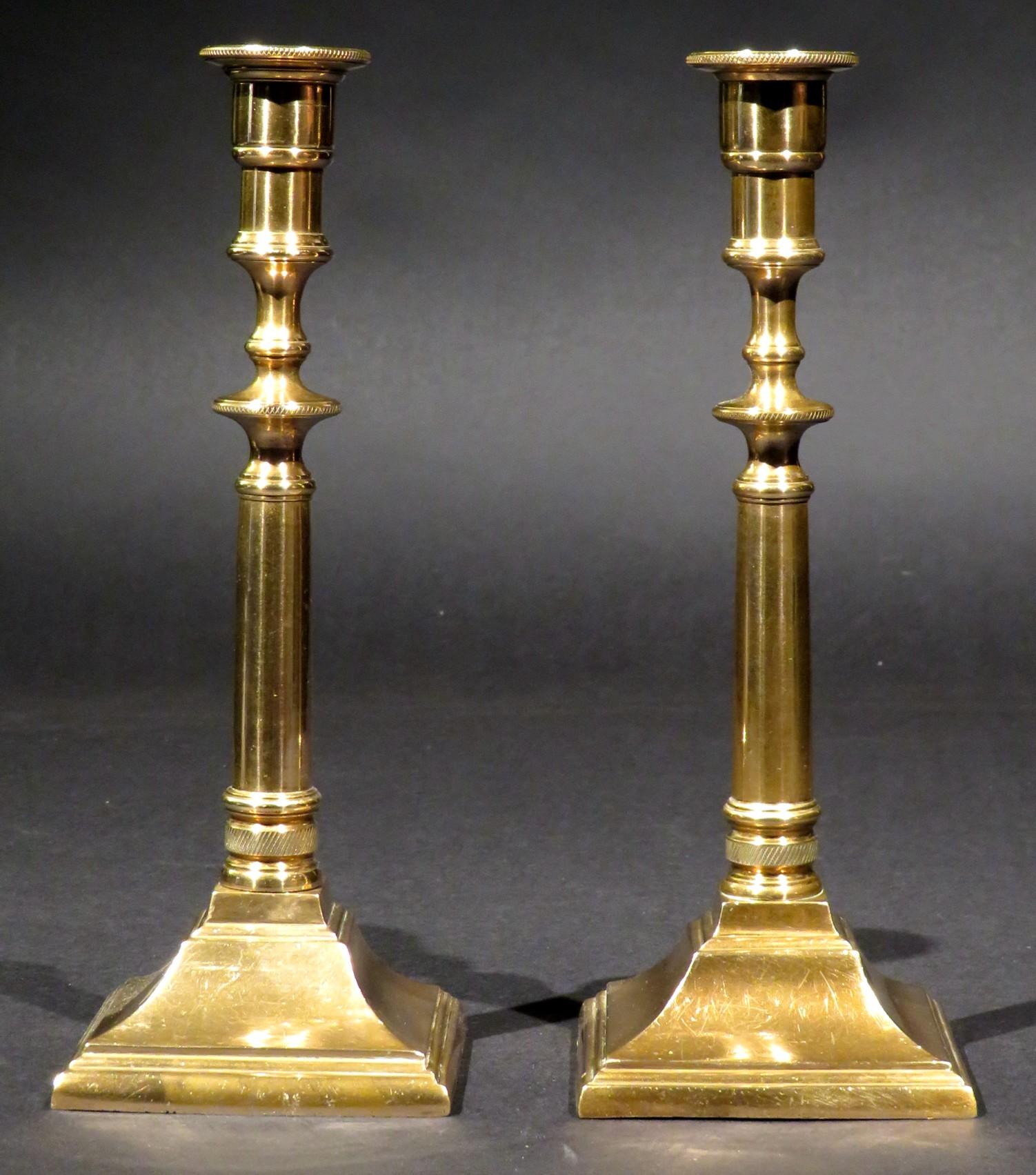 A very handsome & relatively rare pair of 18th century Georgian cast 'bell metal' campaign candlesticks. Both having exceptionally heavy, solid cast columns terminating to threaded posts that allow them to disassemble for ease of use while in