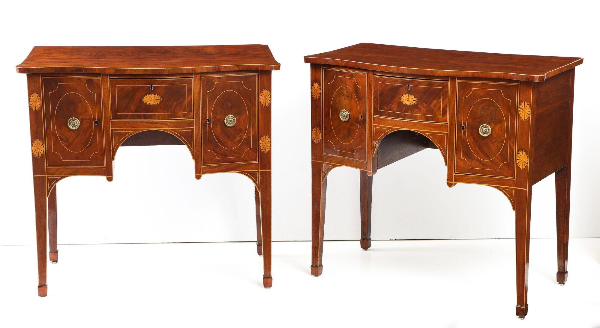 Fine and rare pair of George III mahogany serpentine fronted sideboards, the well figured tops with holly string edge inlay, over patera inlaid legs and central drawer, the flanking doors with string inlaid panels, all with good color and pleasing