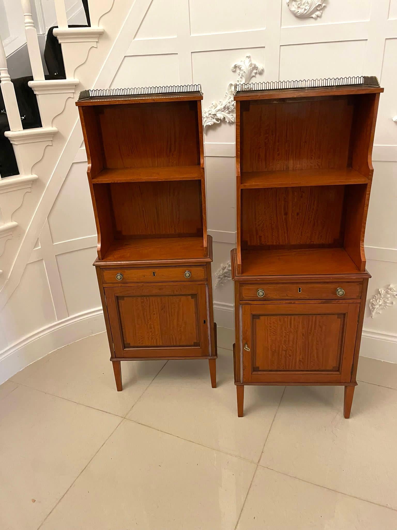 Rare pair of Gillows antique quality satinwood waterfall bookcases having the original brass gallery above a satinwood open waterfall bookcase with crossbanded satinwood backs and tops, one drawer, original brass knobs stamped Gillows above a single