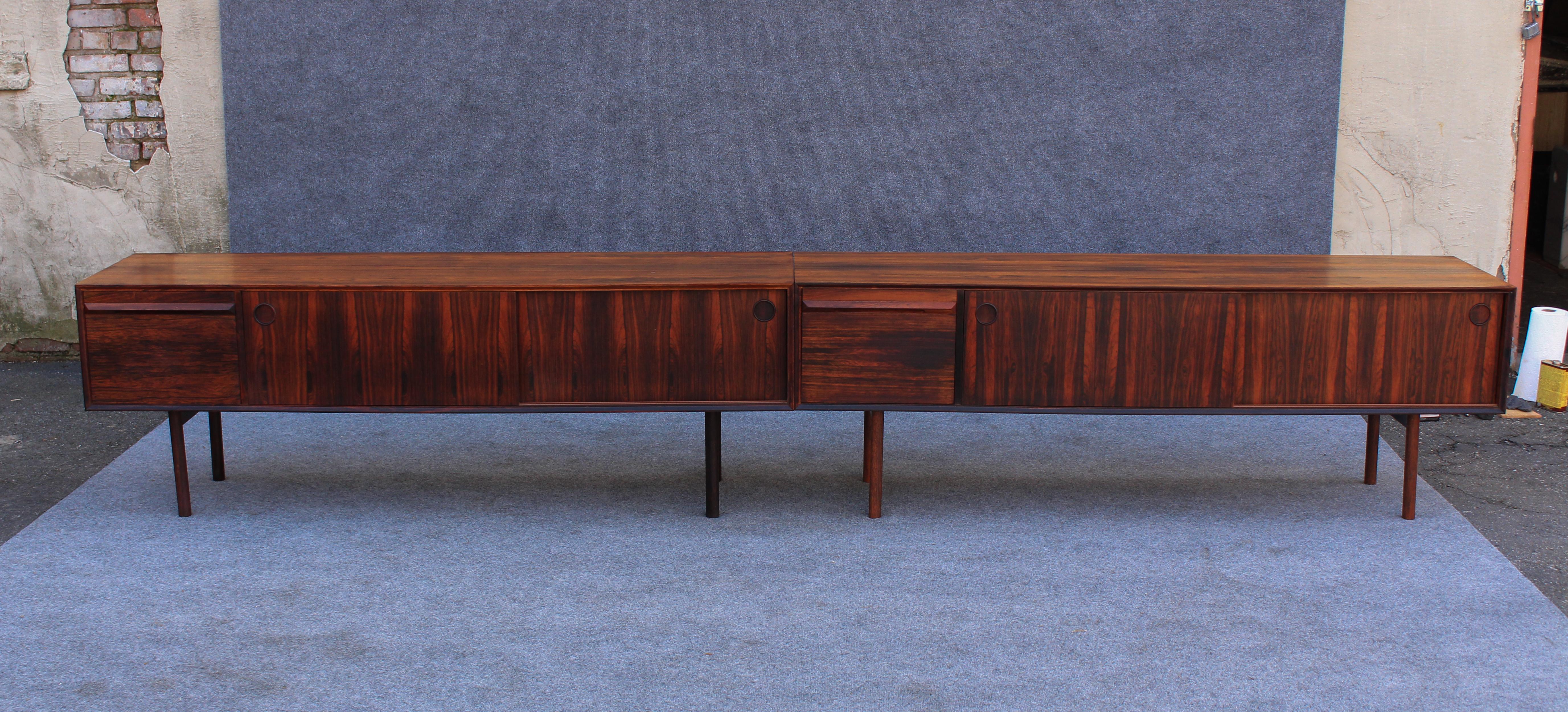 This very rare cabinets were designed in the 1960s by Haug Snekkeri for Danish furniture maker Bruksbo. There were likely only a few hundred ever made, and we have a matching pair. Almost certainly a custom order, these have bookmatched rosewood