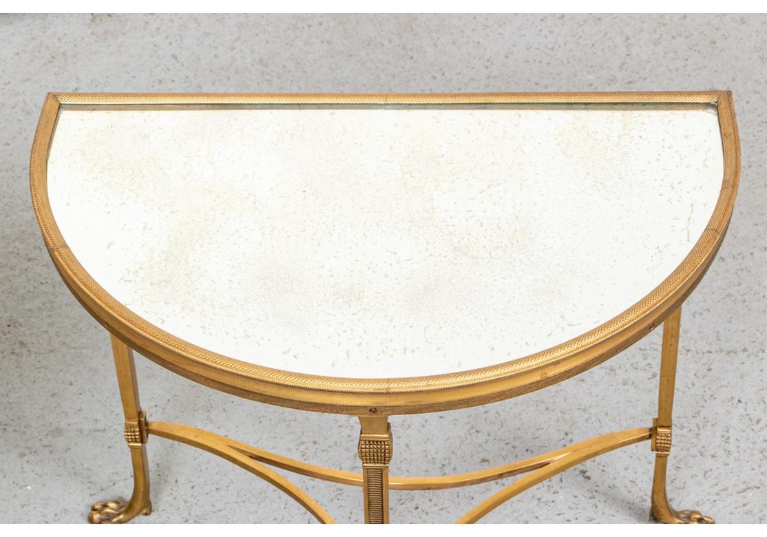 Important pair of gilt bronze French diminutive side tables, Bronze frames having meticulous jewelry type pattern with curved stretchers and delicate paw feet.
Antiqued mirrored top with slight ring impression on one table.
May be used together as