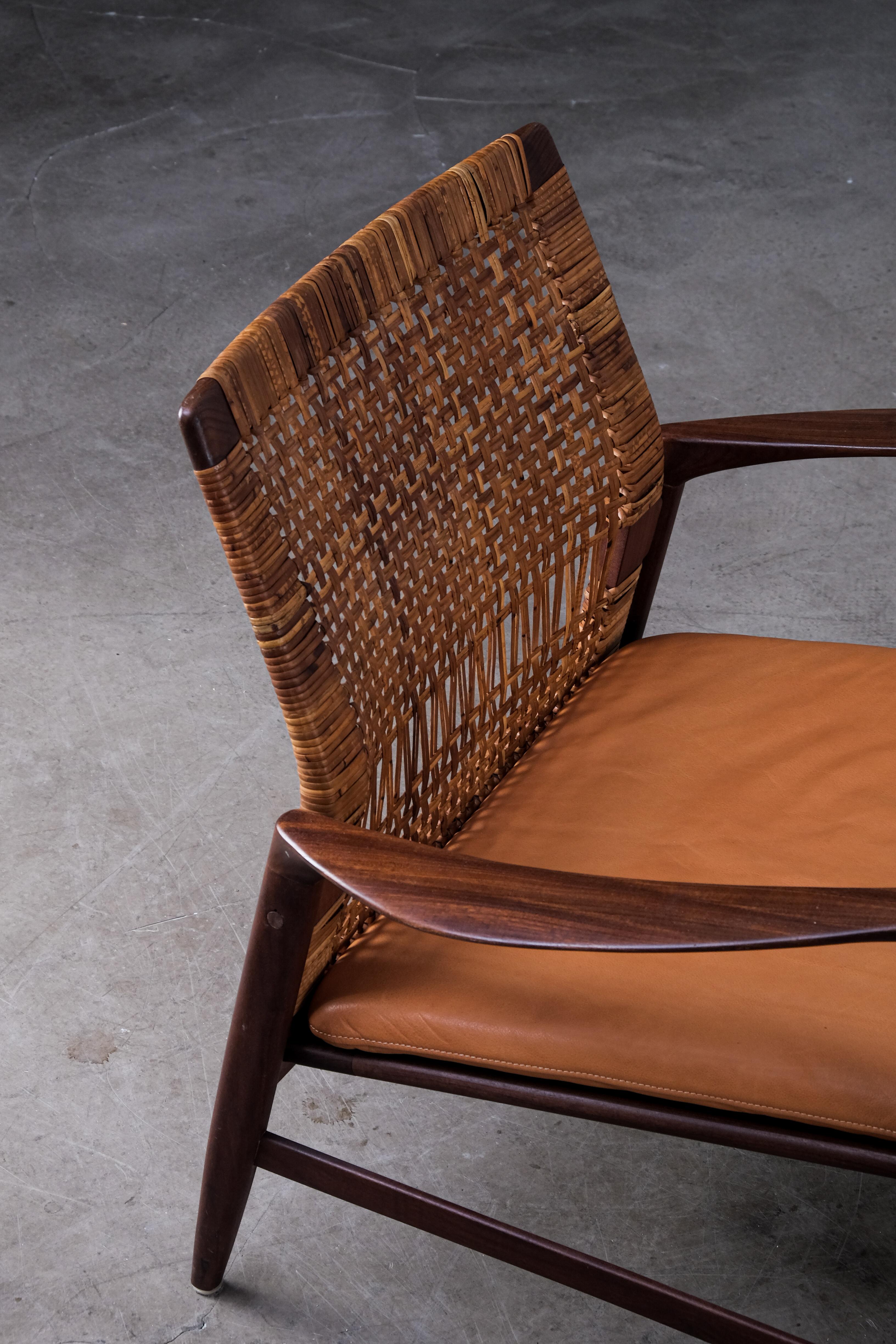 Rare model, produced by OPE, Sweden, 1960s.
Afromosia, rattan/cane and newly reupholstered cushions in leather.