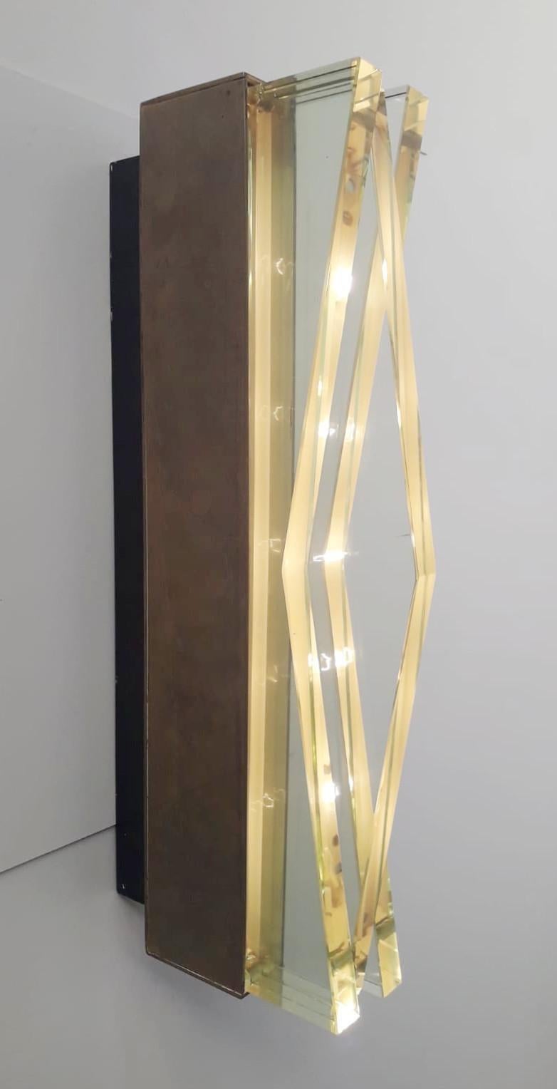 Magnificent rare pair of vintage Italian beveled glass and brass sconces, designed by Max Ingrand and manufactured by Fontana Arte, model 1829, circa 1960s, made in Milan, Italy.