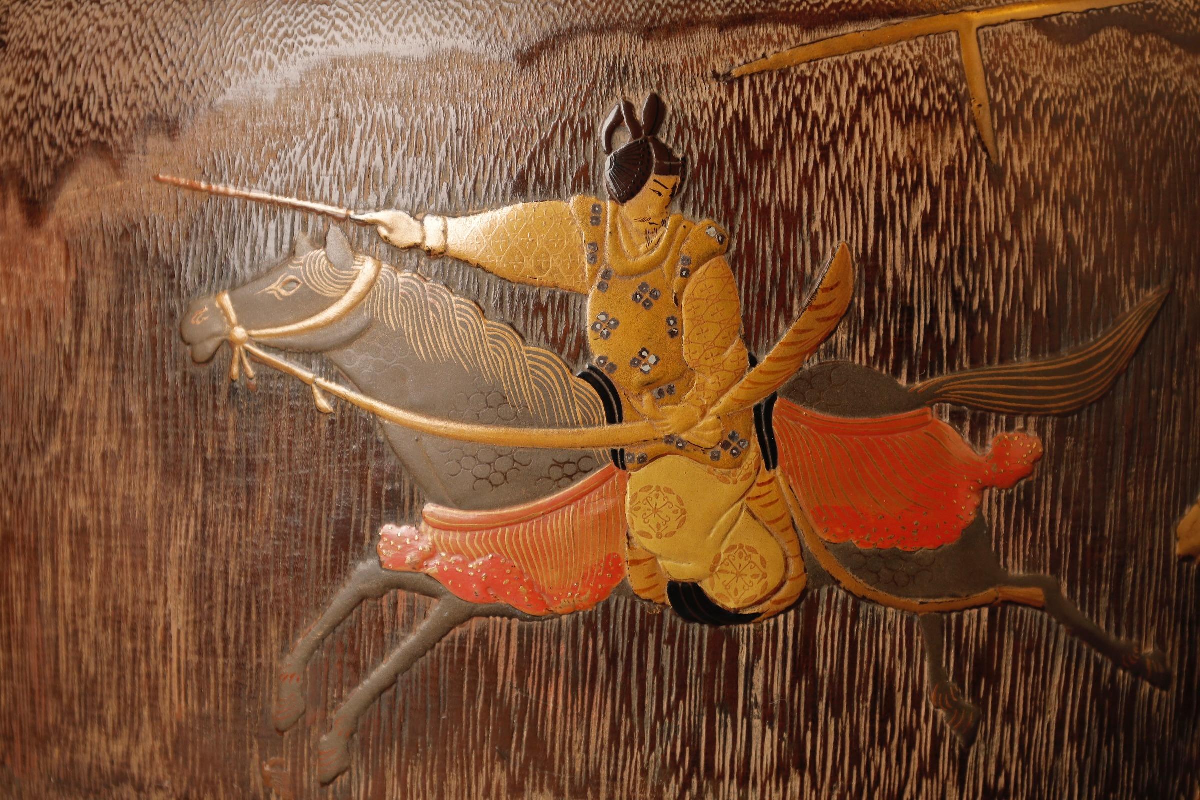 A magnificent and highly rare pair of large Japanese hibachi (charcoal braziers), crafted from kiri wood (paulownia) and lavishly decorated with gold makie lacquer depicting scenes of imperial court horse races — a motif rarely found in domestic