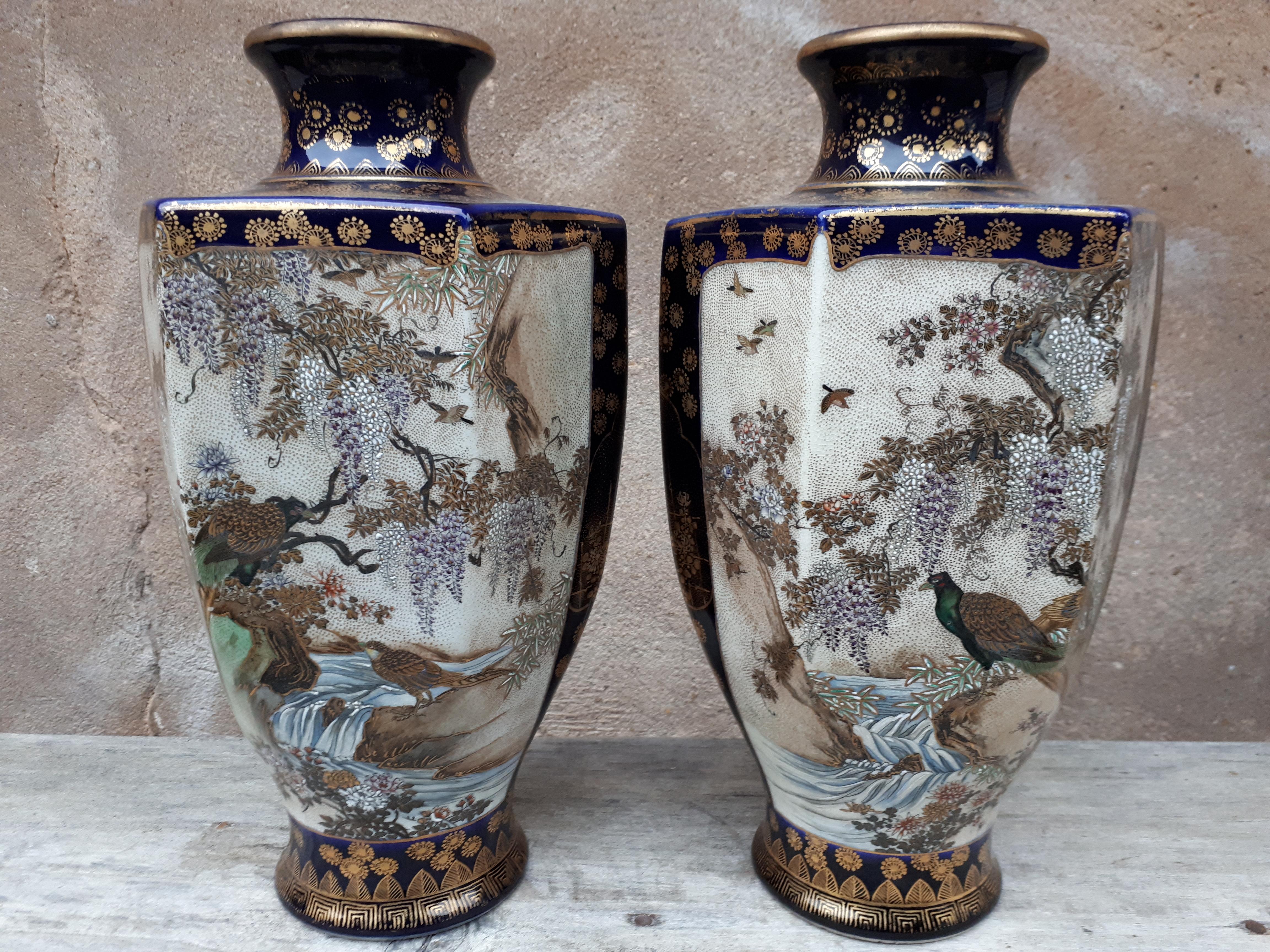 Extremely rare pair of hexagonal Satsuma earthenware vases, with decorations in reserve of birds and landscapes on a blue background enhanced with gold. Signed 